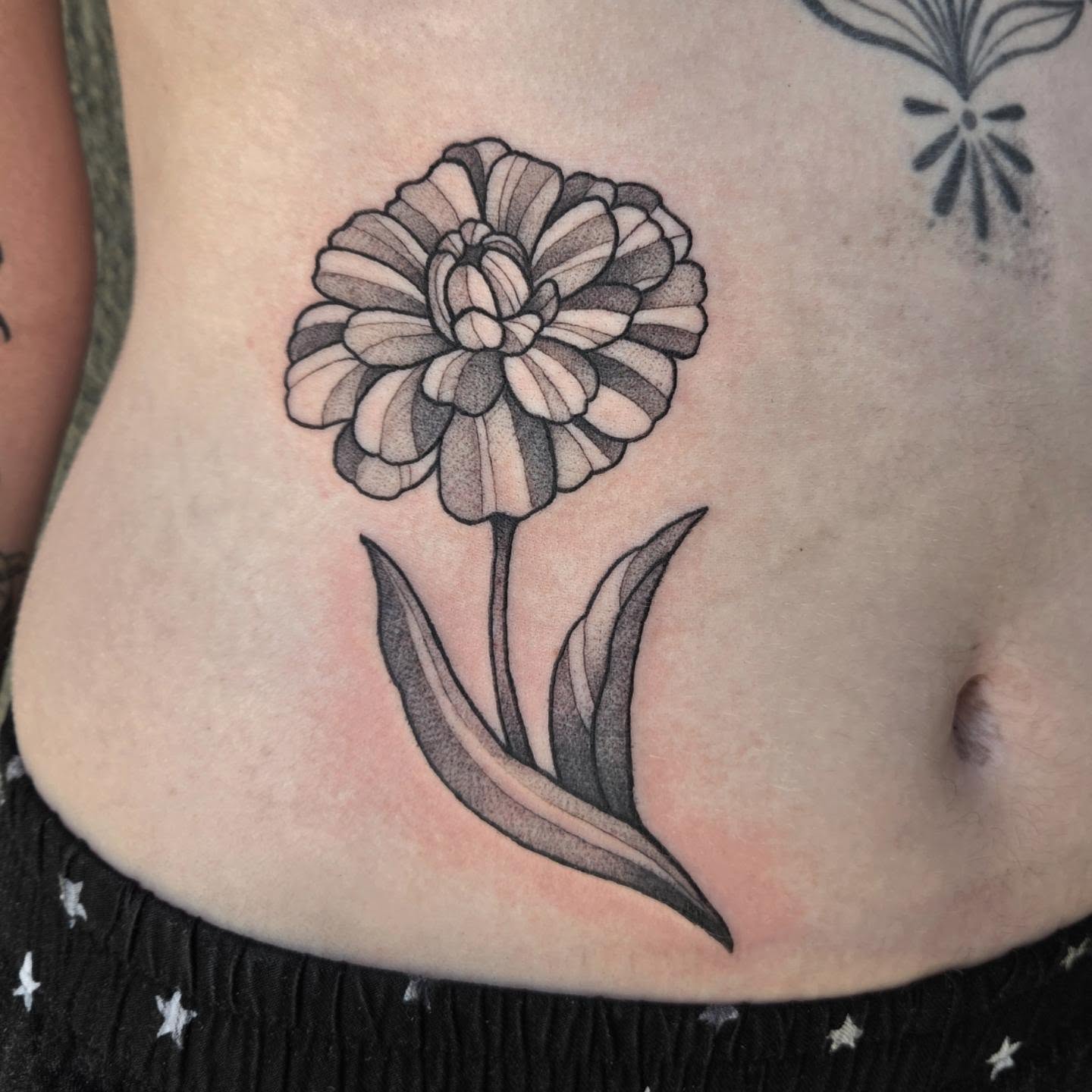 Flower dotwork tattoo on the torso by Taylor