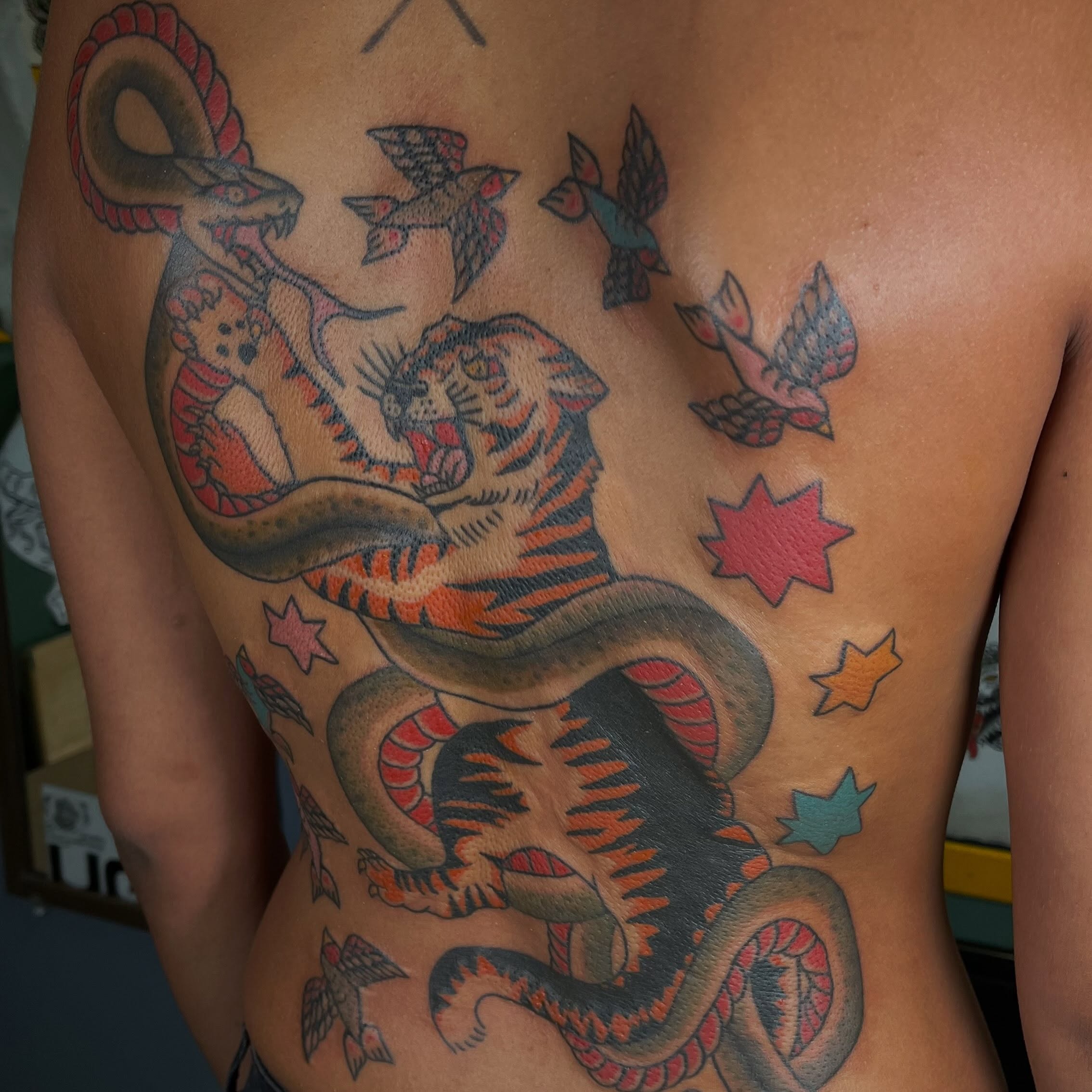 Tiger and snake American traditional tattoo on the back by Jennifer Medrano