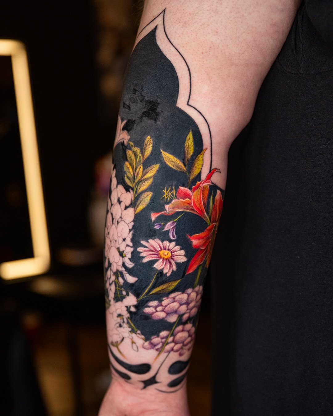 Floral bouquet new school tattoo on the forearm by Ori Merchan Tattoo, Kansas City, Missouri