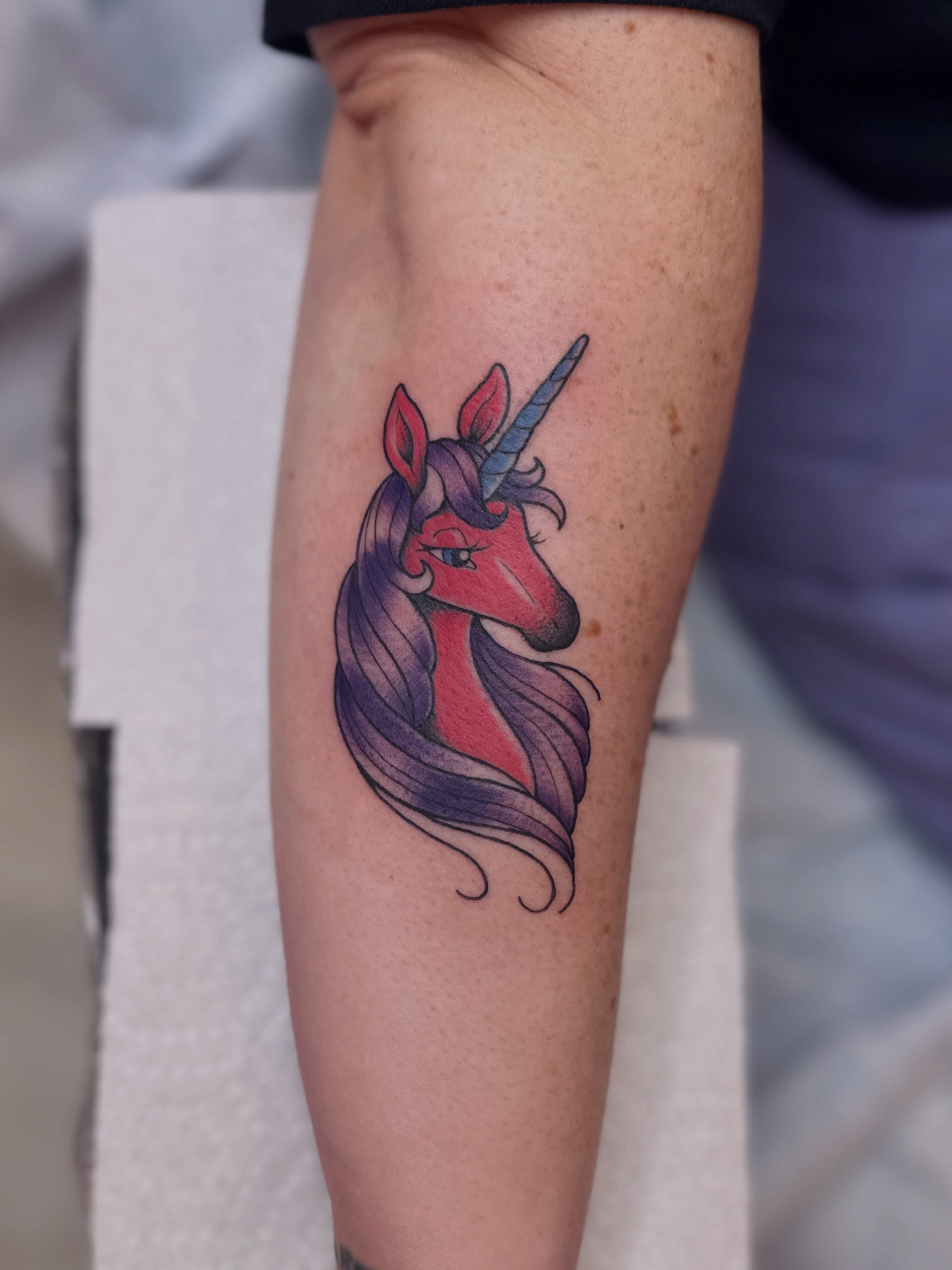 Unicorn new school tattoo on the forearm by Dani Di Pietrantonio