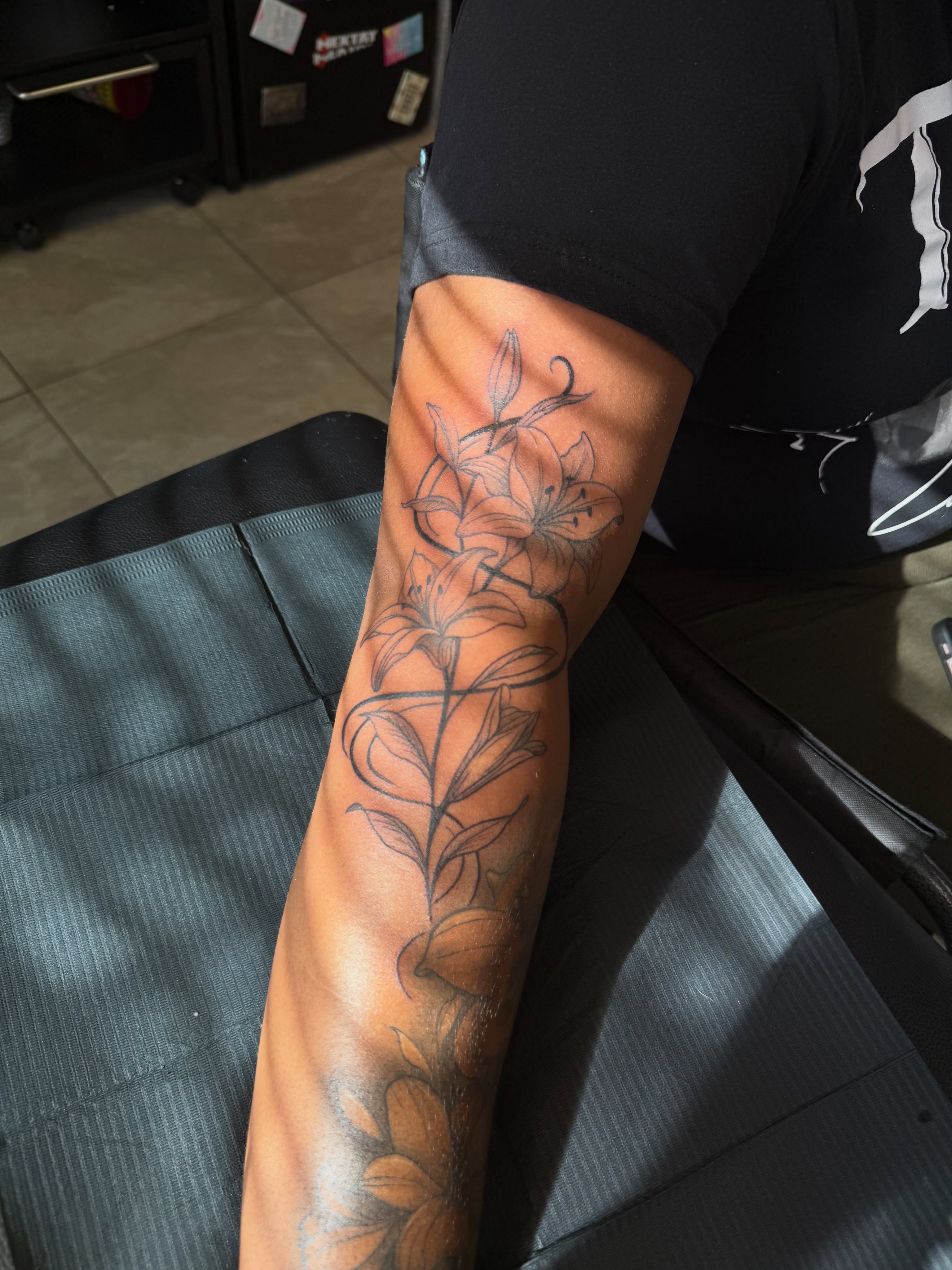 Lilies black and grey tattoo on the forearm by XoticTherapy, Las Vegas, Nevada