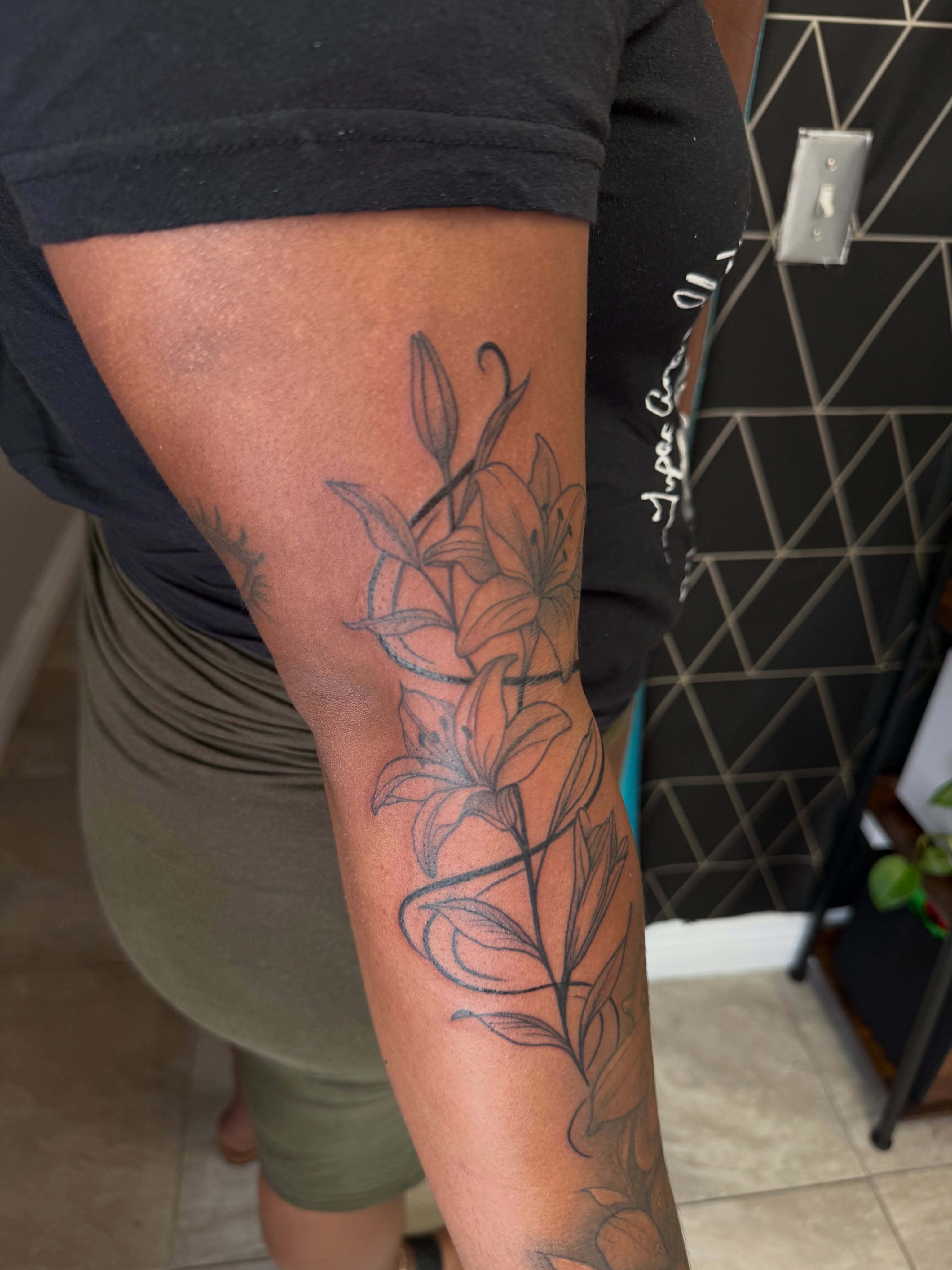 Lilies black and grey tattoo on the forearm by XoticTherapy, Las Vegas, Nevada