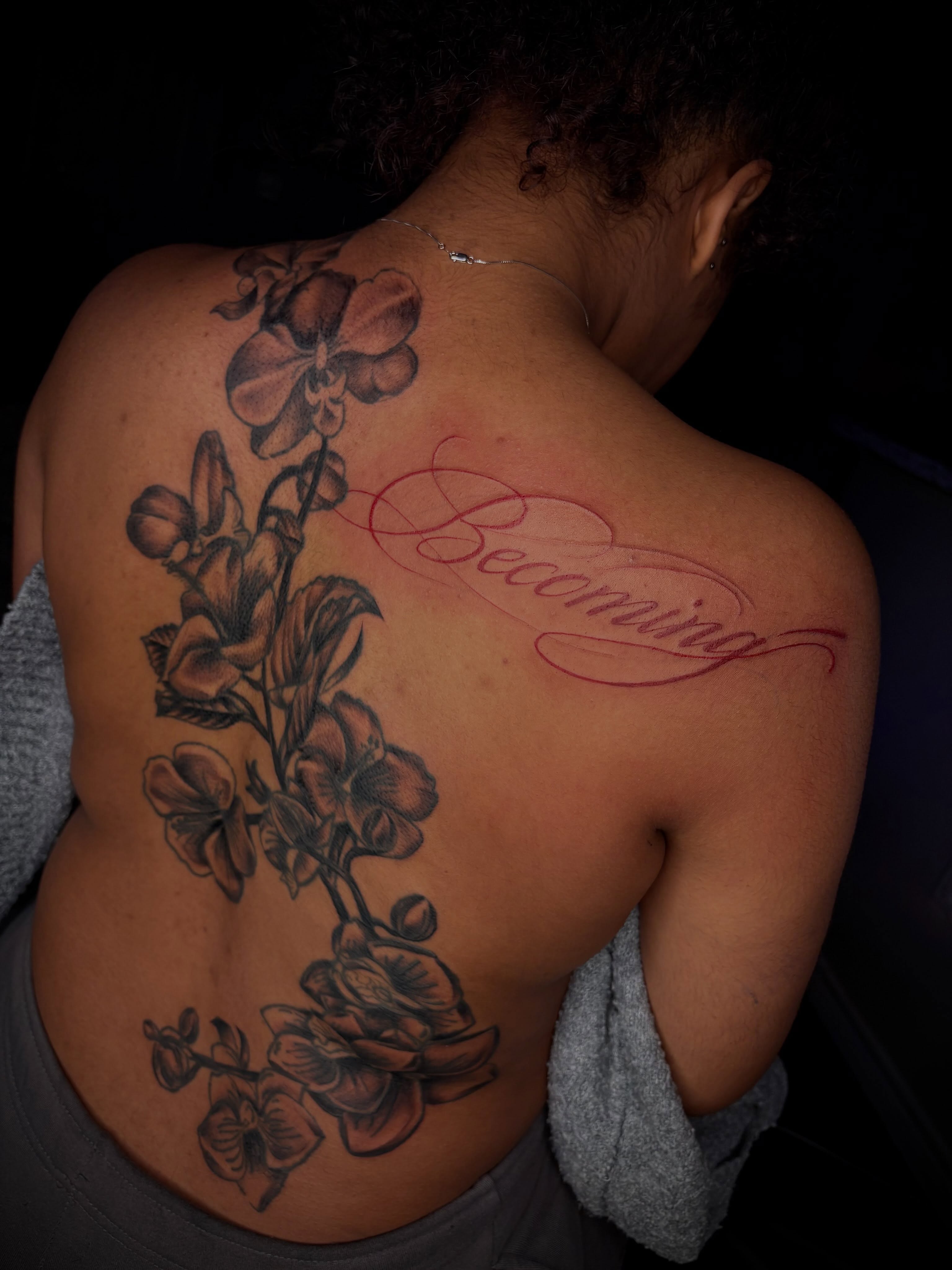 Orchids and cursive realism tattoo on the back by ✧ Dallas Tattoo Artist  ✧