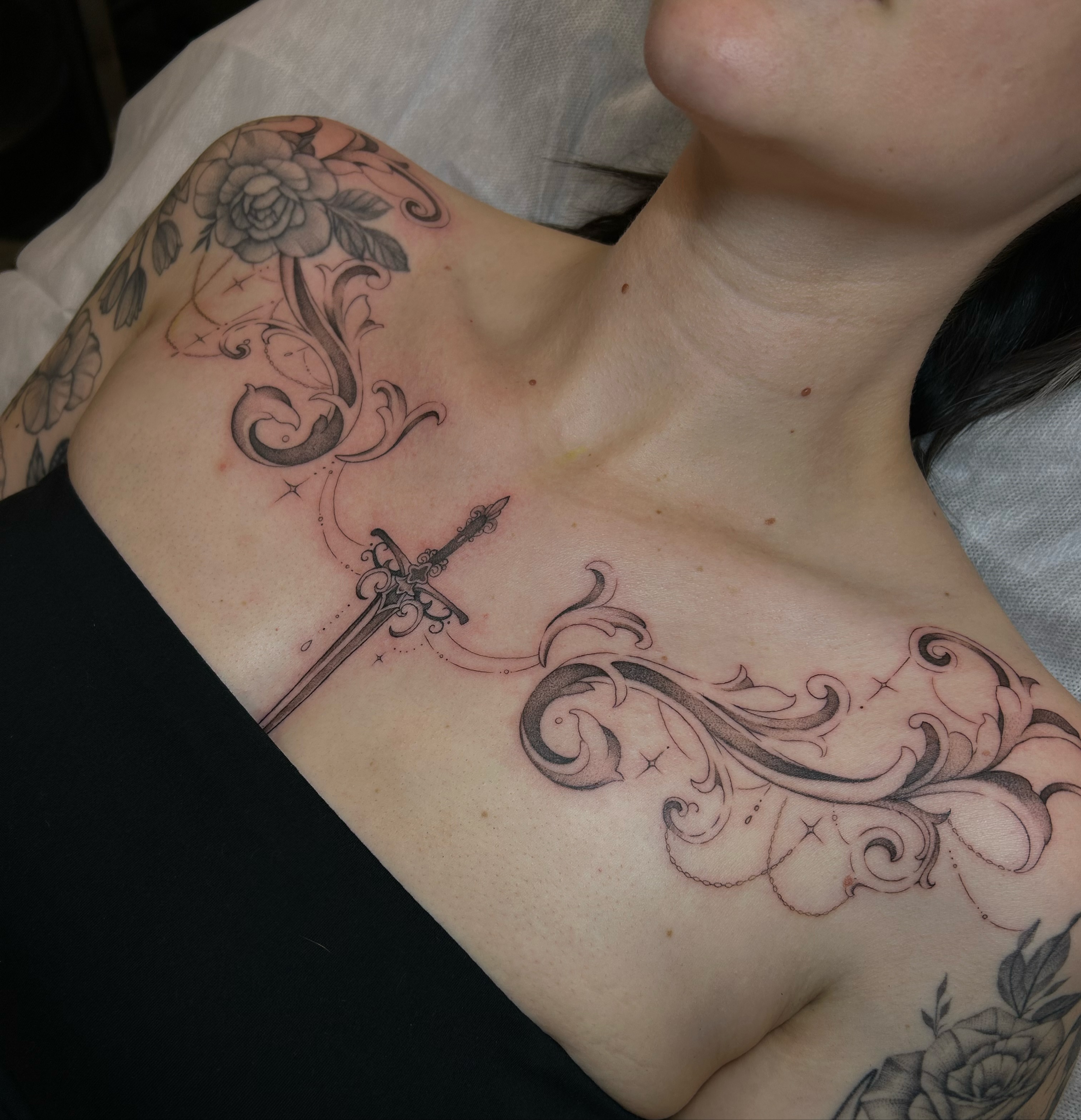 Sword and floral ornamental tattoo on the chest by alyssa jade ⭐️