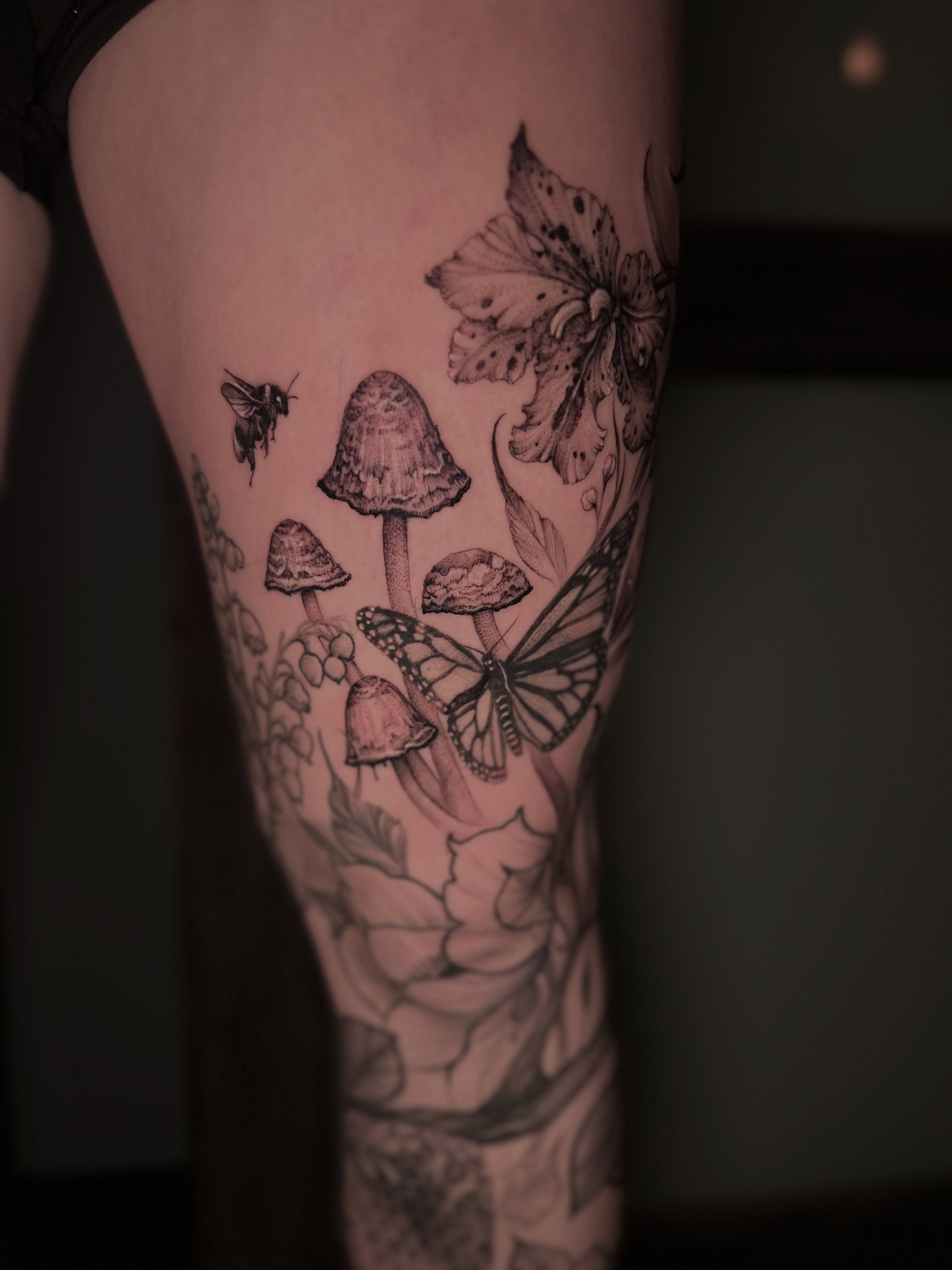 Mushrooms, butterflies, flowers realism tattoo on the forearm by Dominick Cali, East Islip, New York