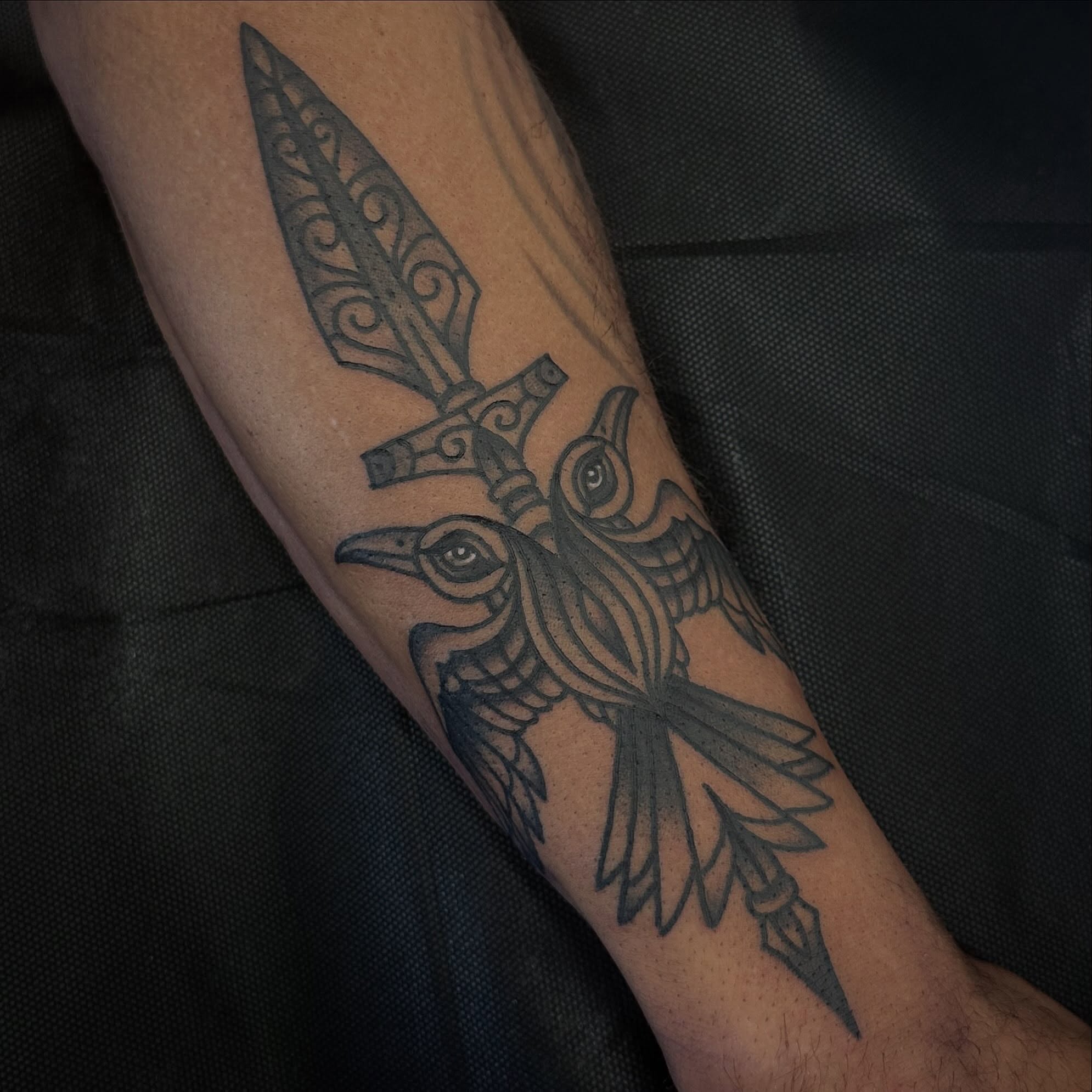 Crow and spear black and grey tattoo on the forearm by Bryan Humphries