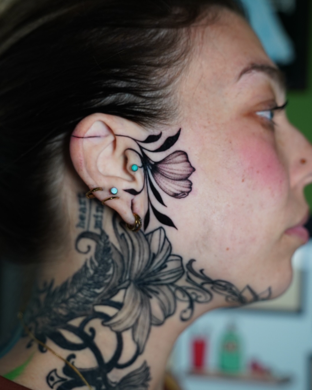 Flower and vine black and grey tattoo on the neck by Kirsten Cameron