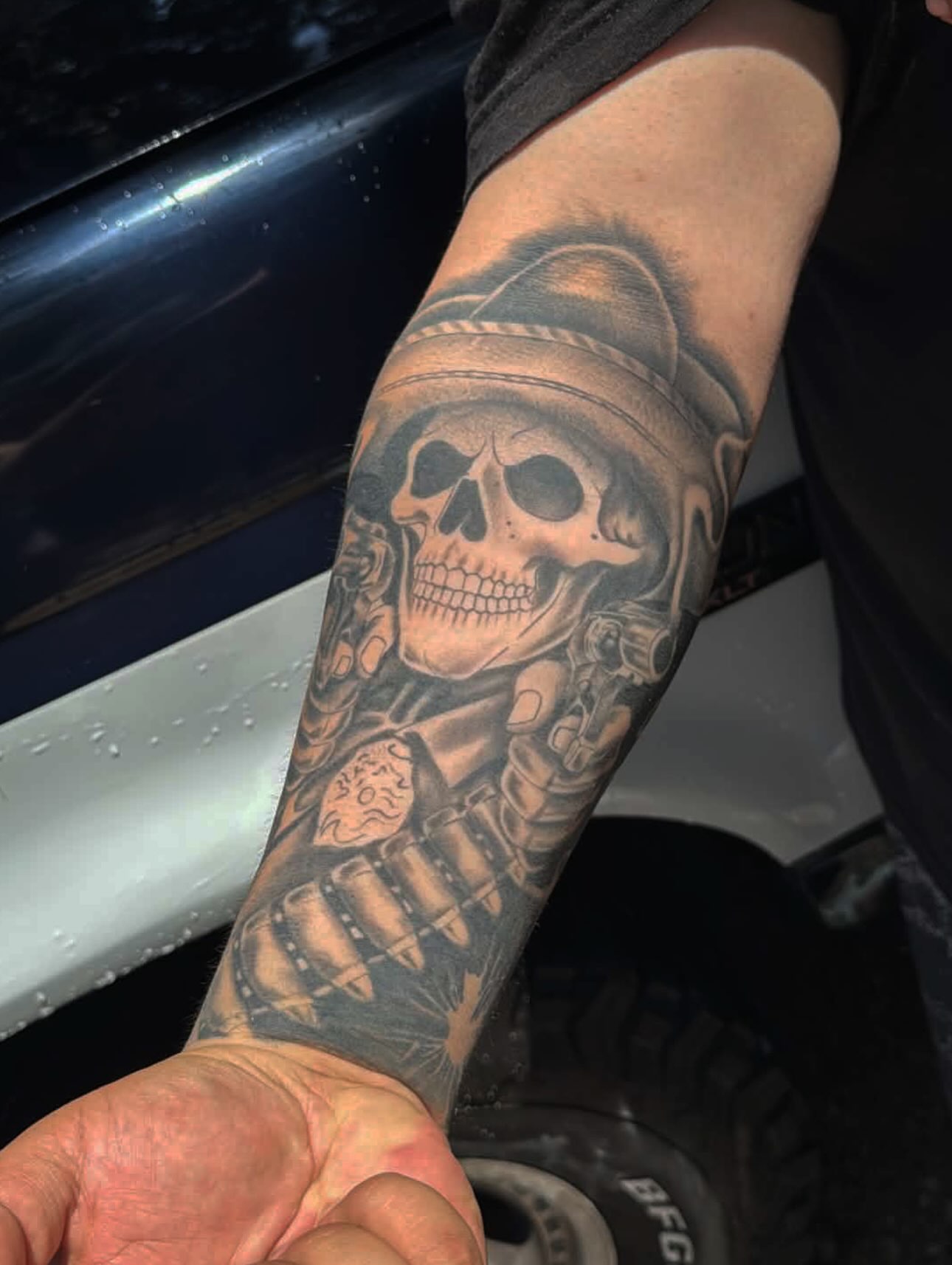 Skull with hat and bullets realism tattoo on the forearm by Dallas tx tattoo artist ✝️
