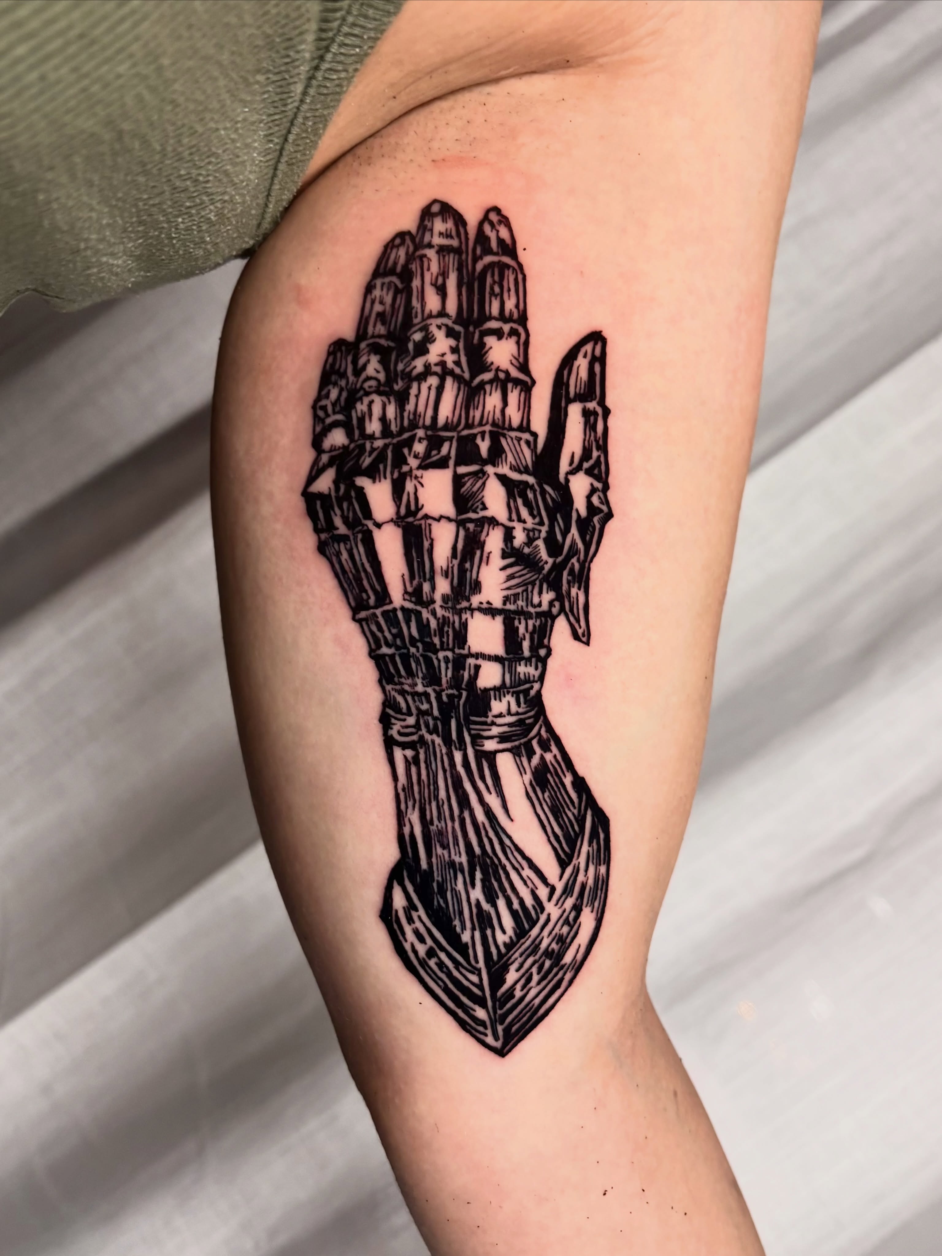 Praying hands black and grey tattoo on the forearm by Wren Cavanaugh Tattoos, Seattle, Washington