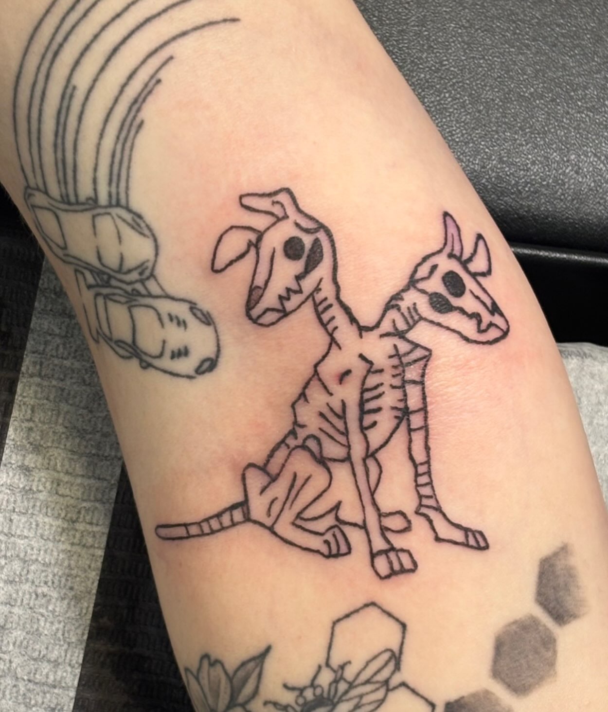 Giraffe skeleton black and grey tattoo on the forearm by Natalie Jade Shupe