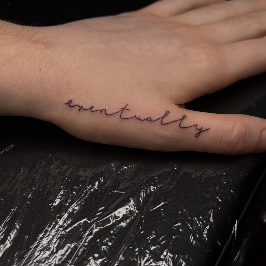 Eventually lettering script tattoo on the hand by Pretty Ugly Tattoos