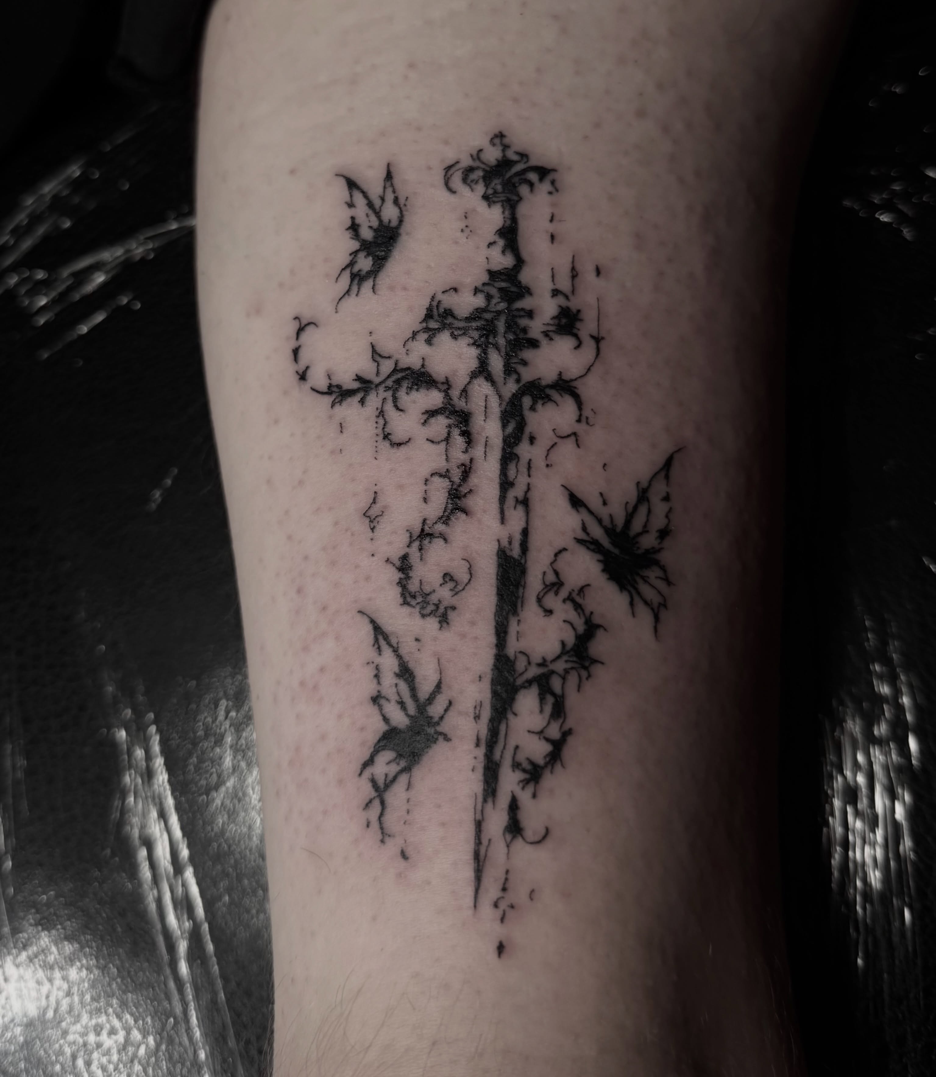 Sword and butterflies ornamental tattoo on the forearm by Jordan Sandoval