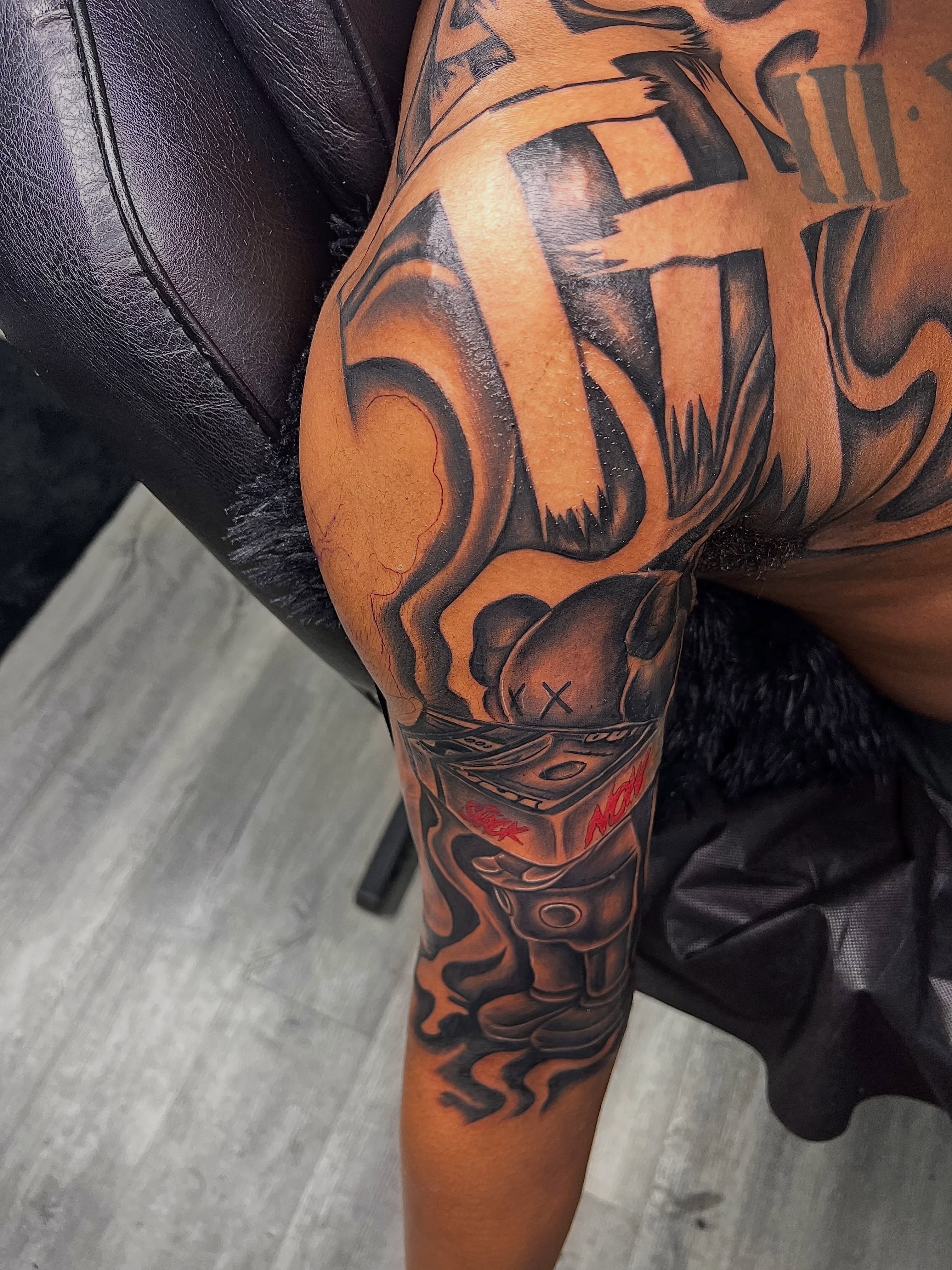 Mask with flame dark realism tattoo on the thigh by Deonte Dwayne Durham