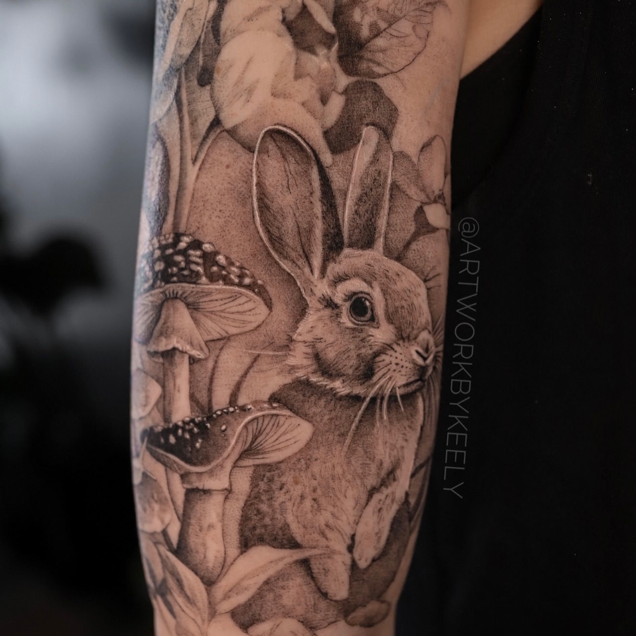 Rabbit and mushrooms dotwork tattoo on the forearm by Keely Thompson