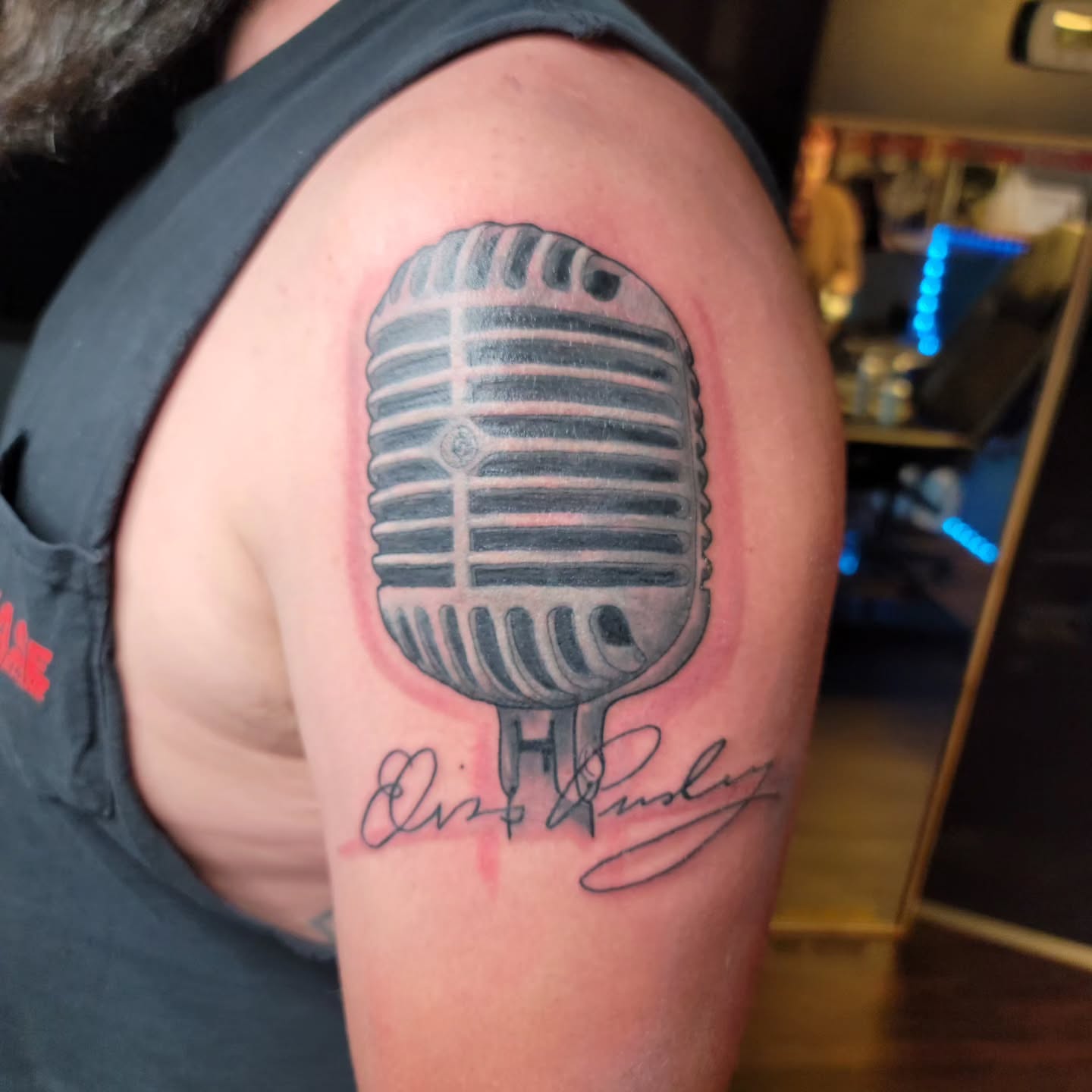 Microphone black and grey tattoo on the shoulder by Captain Michael Devious
