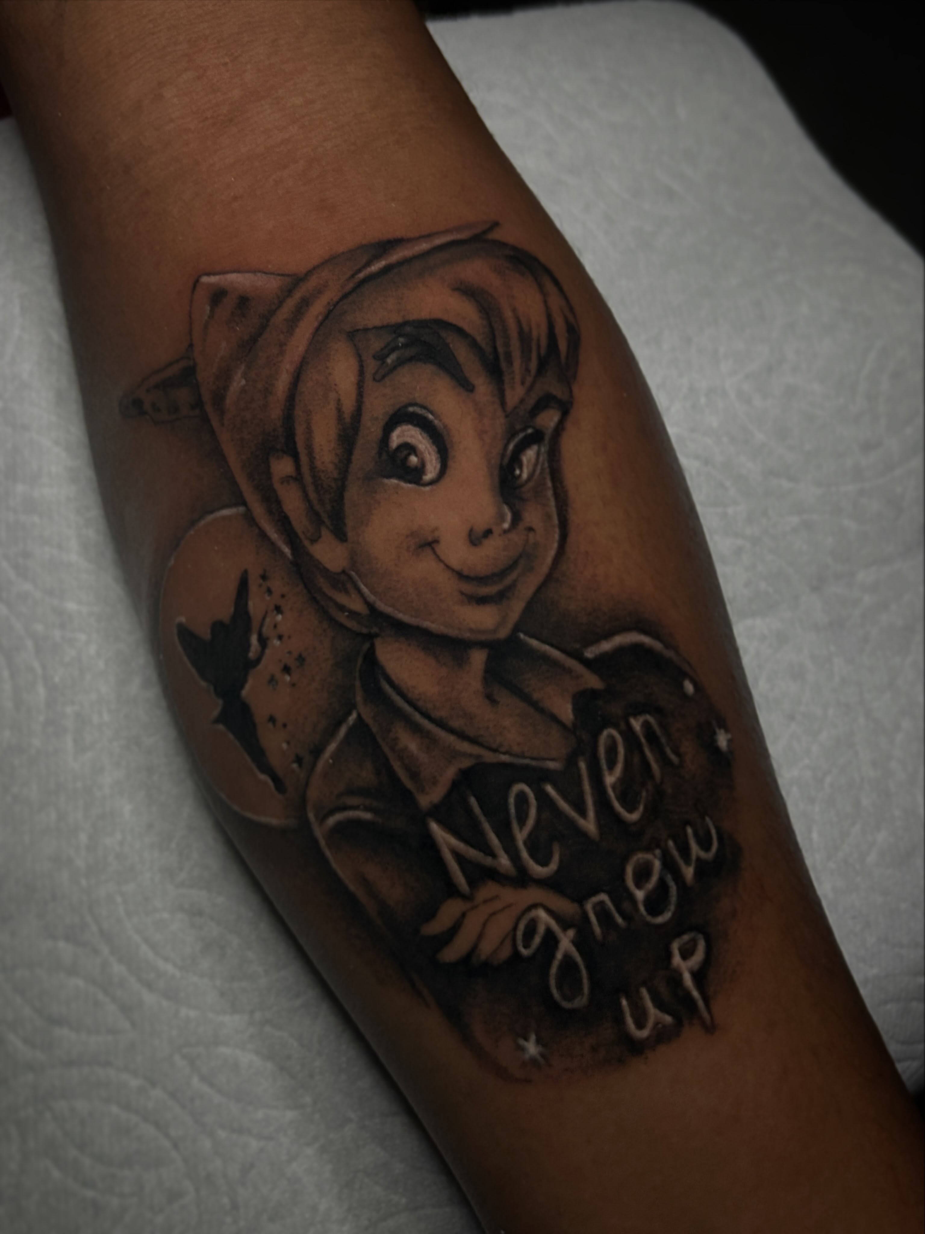 Peter Pan black and grey tattoo on the forearm by Marky