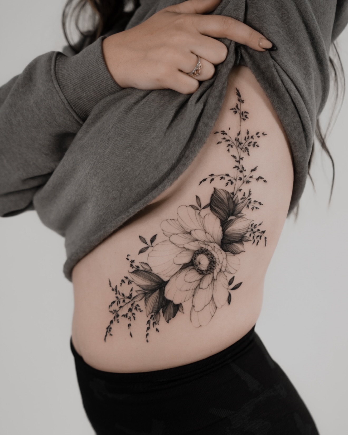 Floral bouquet black and grey tattoo on the ribs by Marek