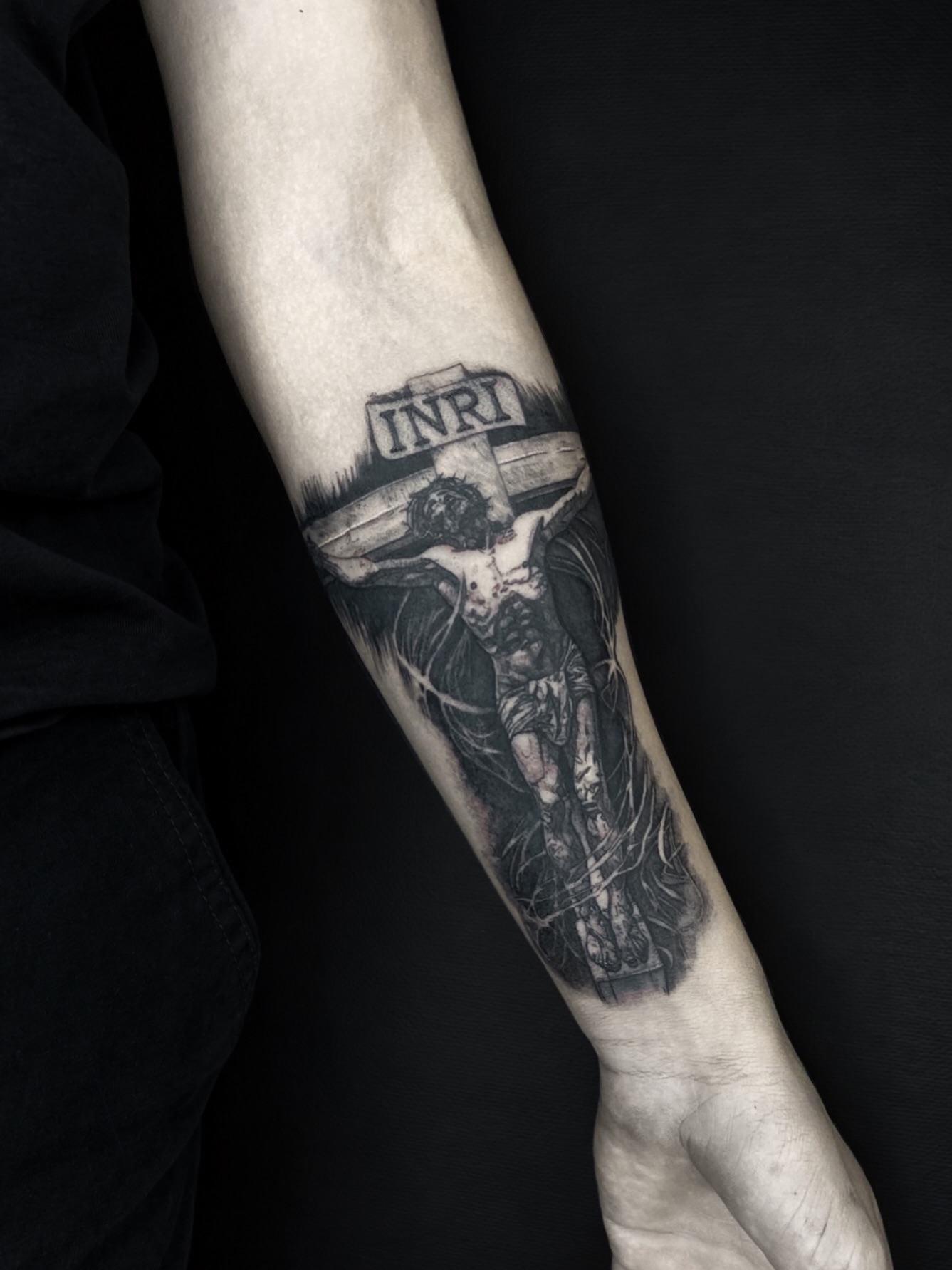 Crucifixion scene realism tattoo on the forearm by Alexey Molyarenko