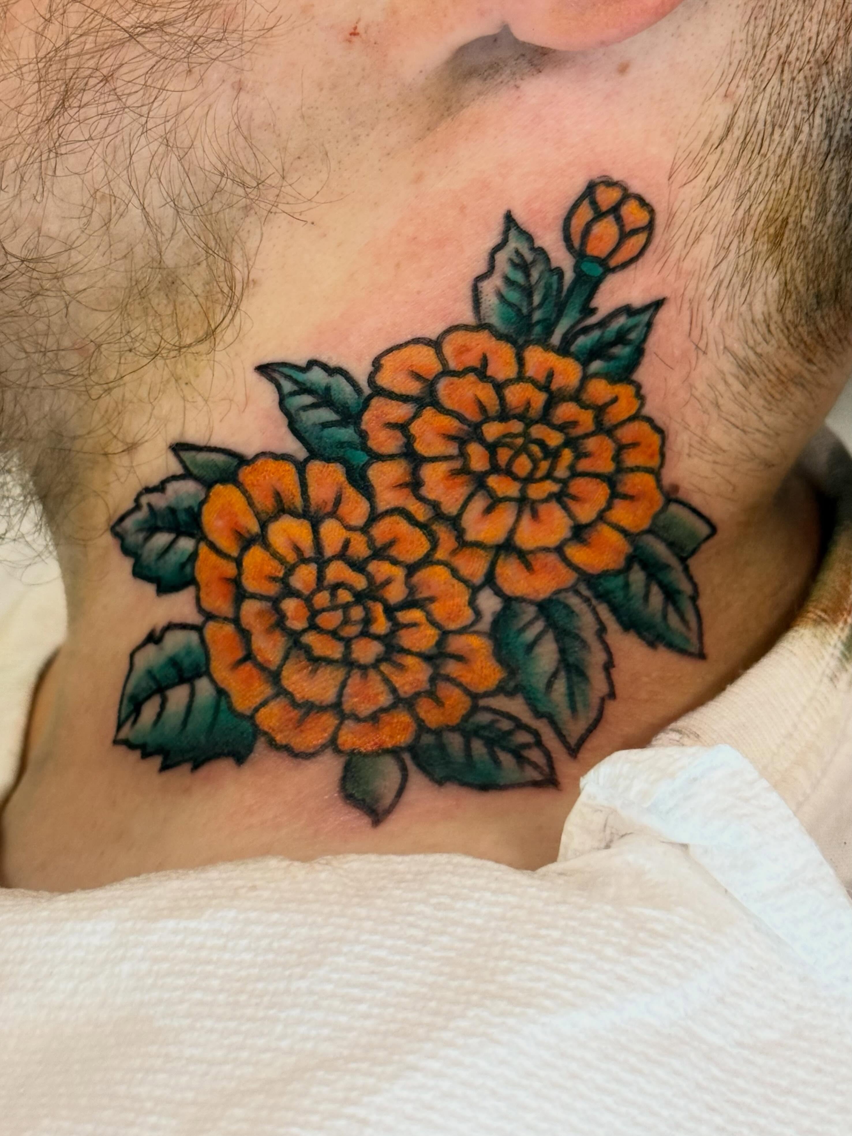 Marigolds American traditional tattoo on the chest by Jesse Boss, Nashville, Tennessee