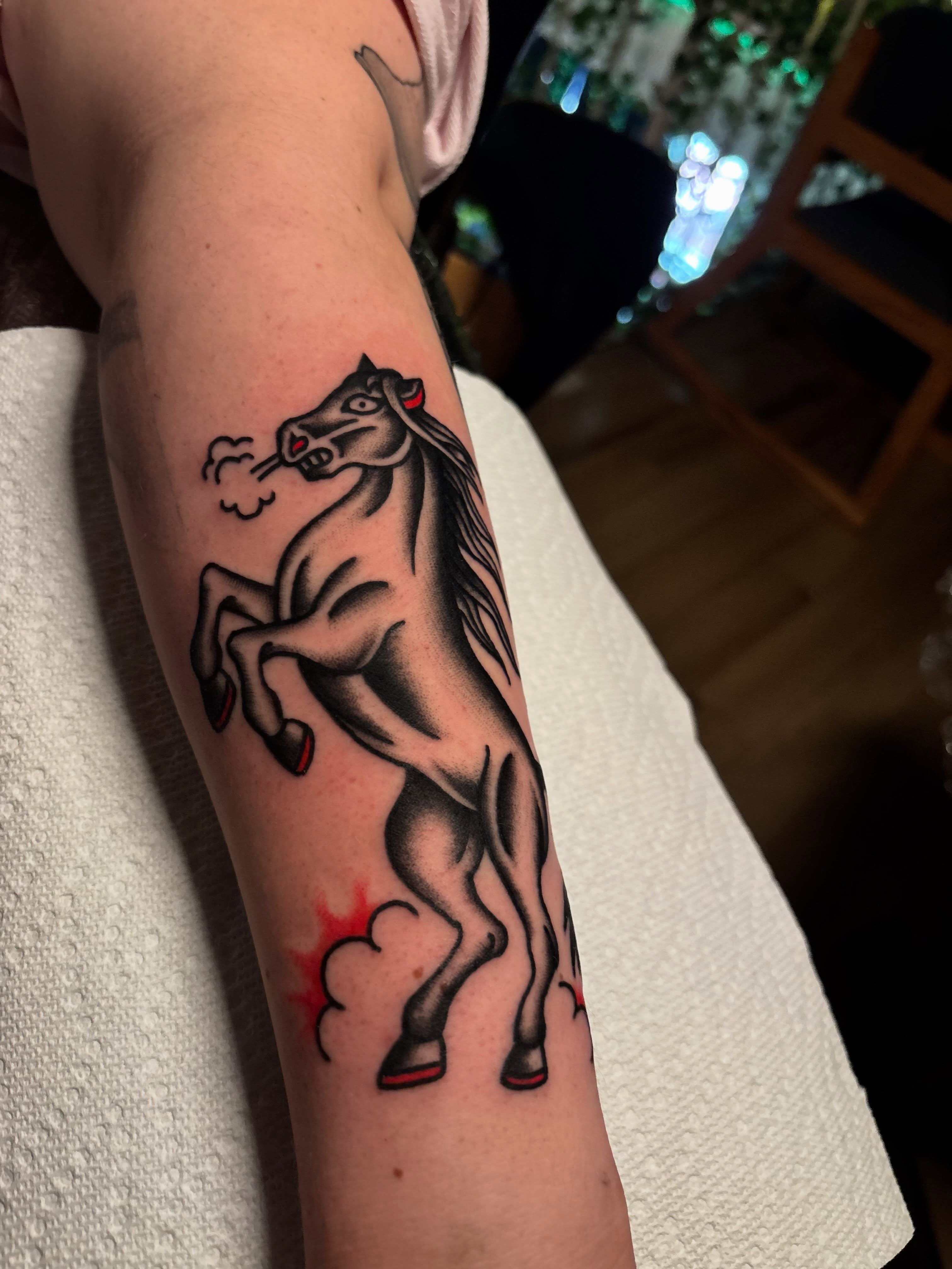 Rearing horse American traditional tattoo on the forearm by Tyler Whalen
