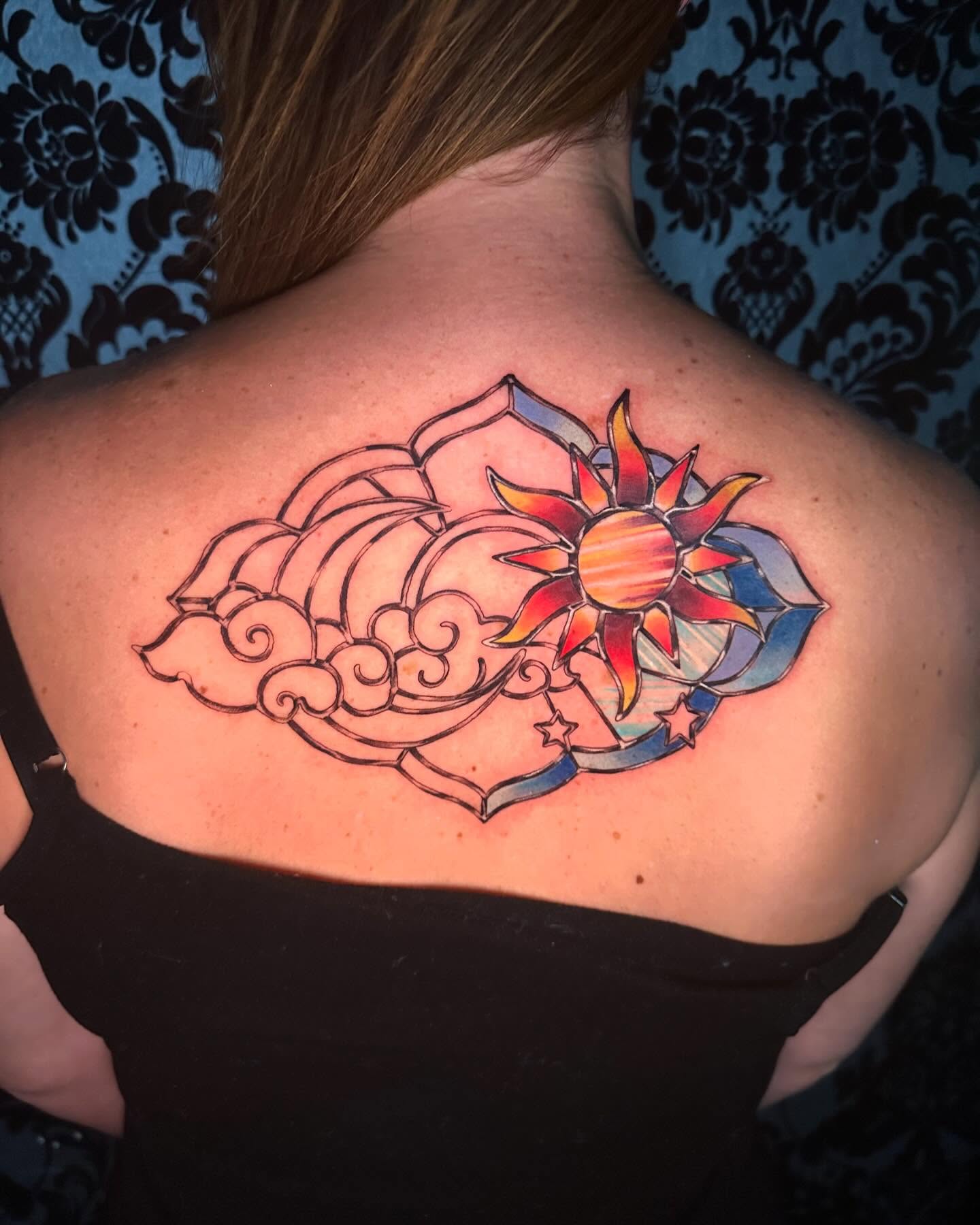 Sun and clouds new school tattoo on the back by Cassandra Rasper-Beard