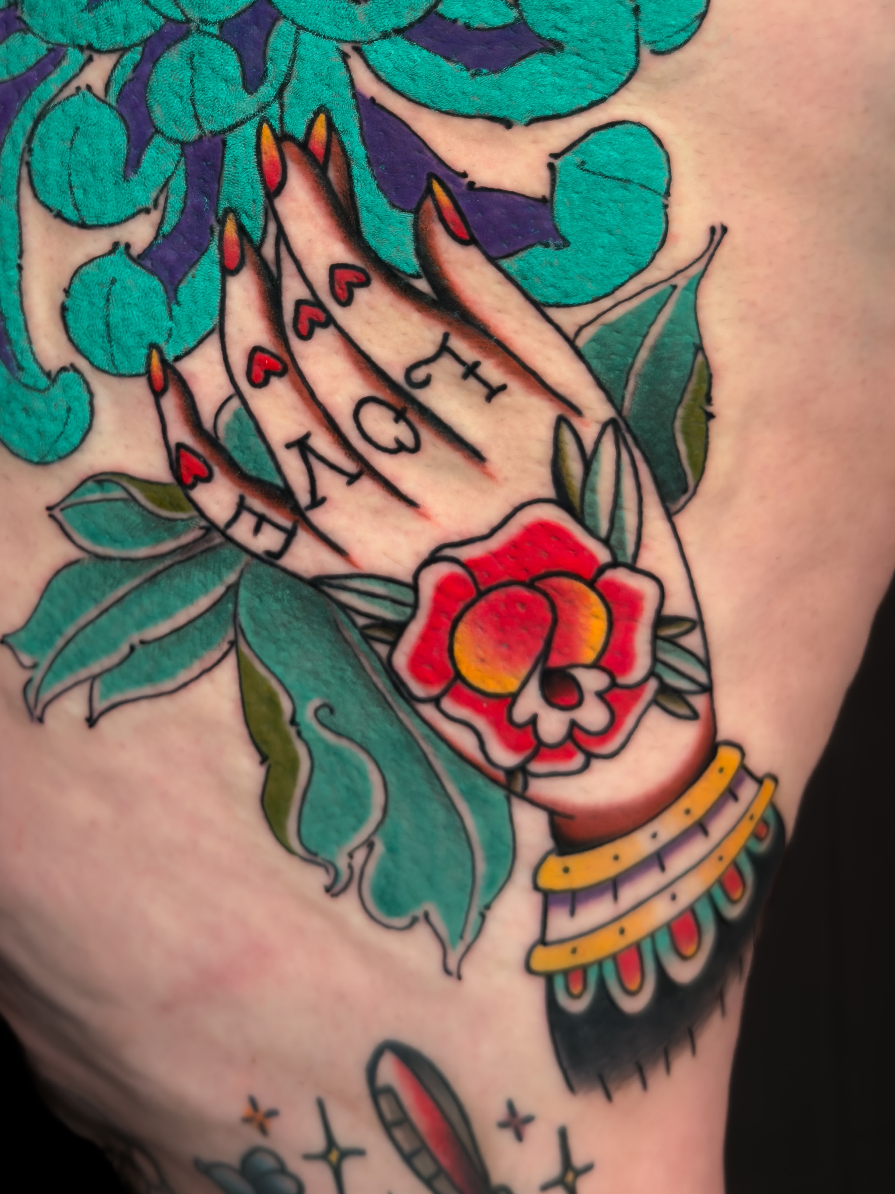 Hands and rose American traditional tattoo on the shoulder by Igor Puente