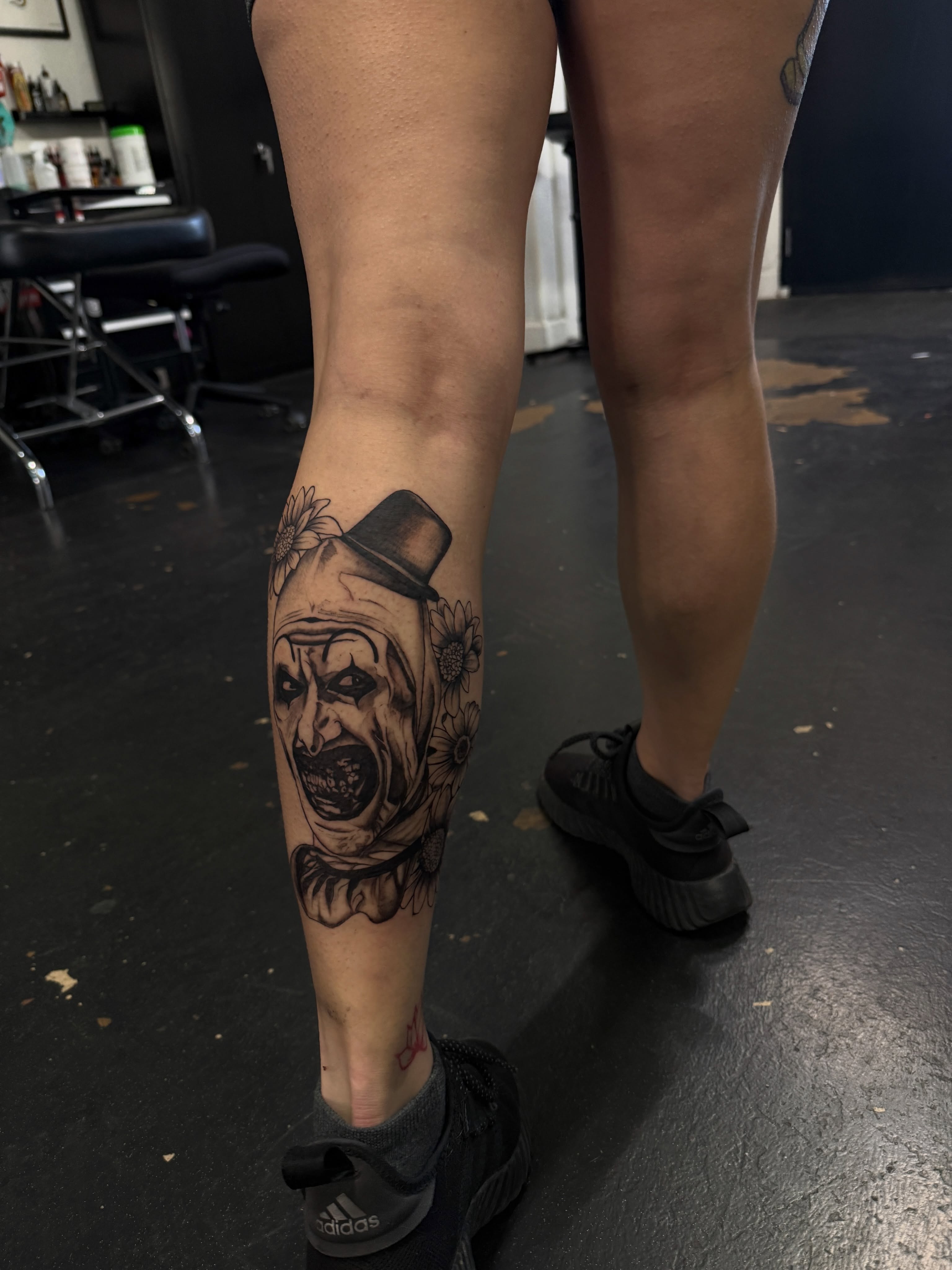 Clown with flowers black and grey tattoo on the calf by sierra 💌⛓️