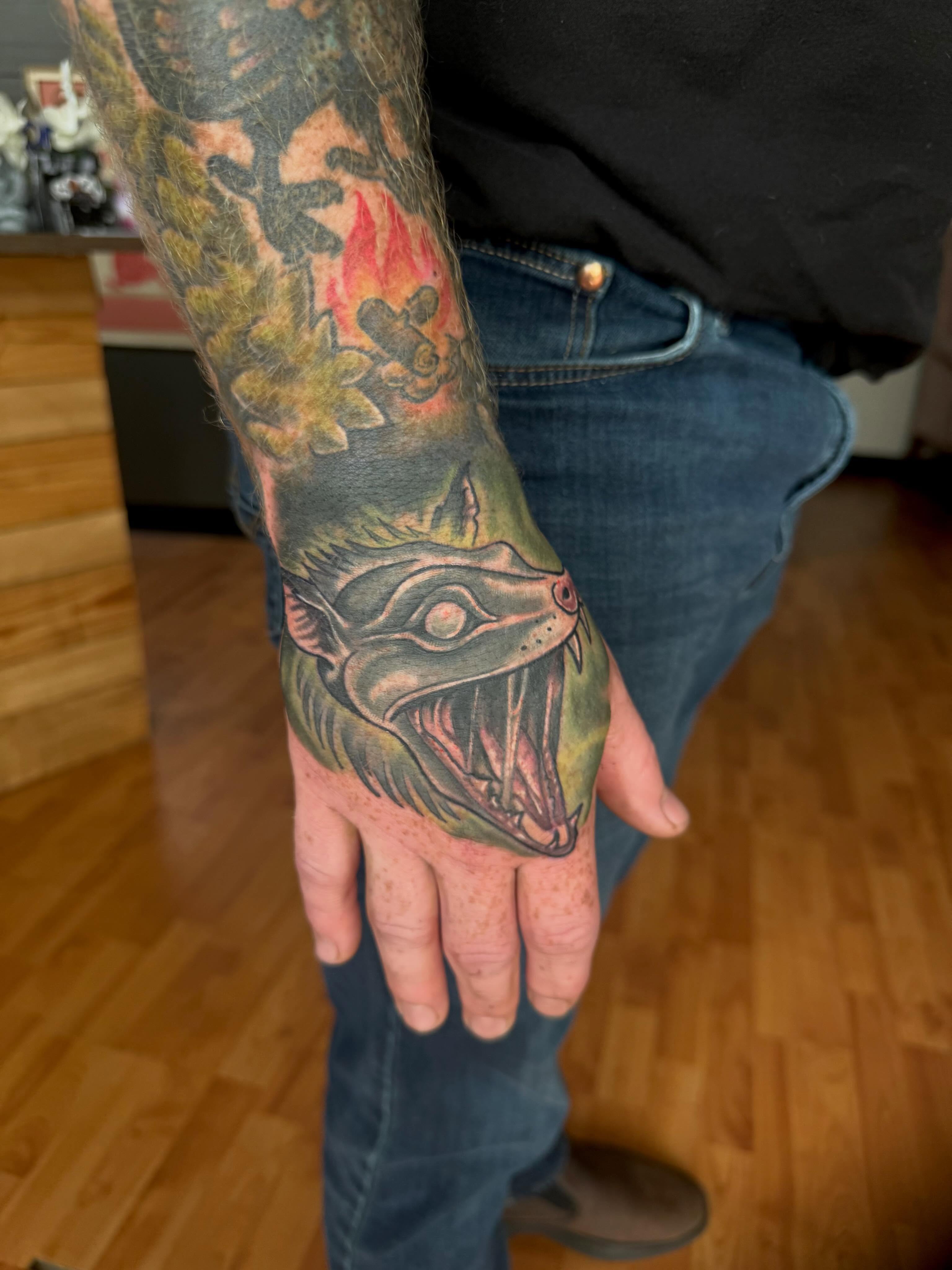 Serpent American traditional tattoo on the hand by Aaron Ysidro