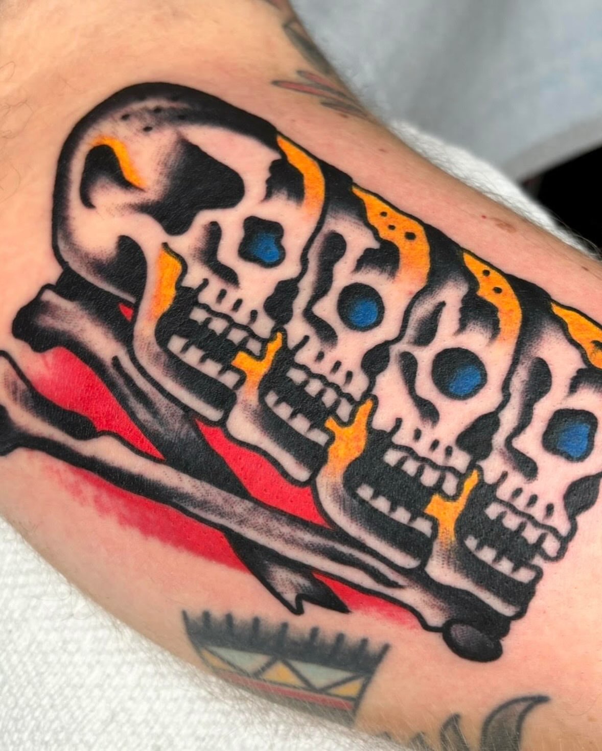 Skulls and bones American traditional tattoo on the forearm by ~pooty~