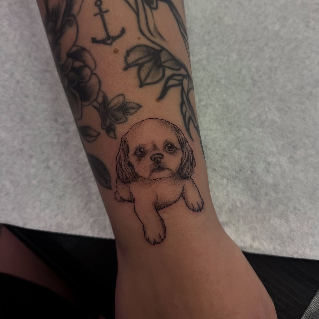 Puppy realism tattoo on the forearm by Kat Bennett