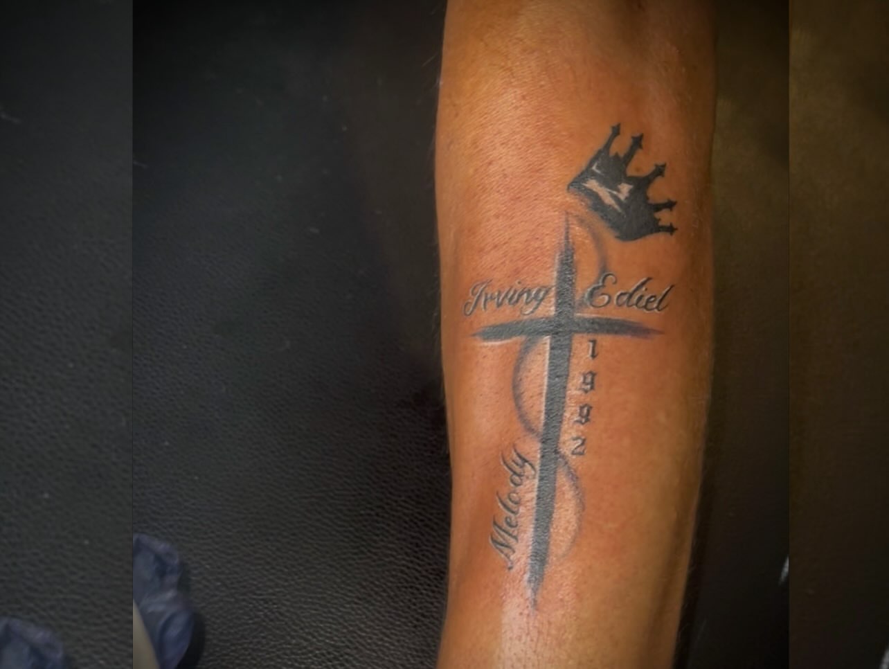 Cross with crown black and grey tattoo on the forearm by Tu SanchoTattoos