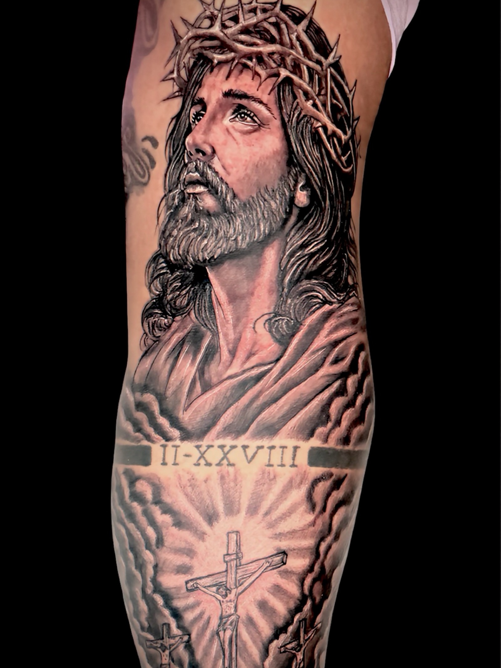 Religious figure realism tattoo on the forearm by Junior Sanchez Dfw