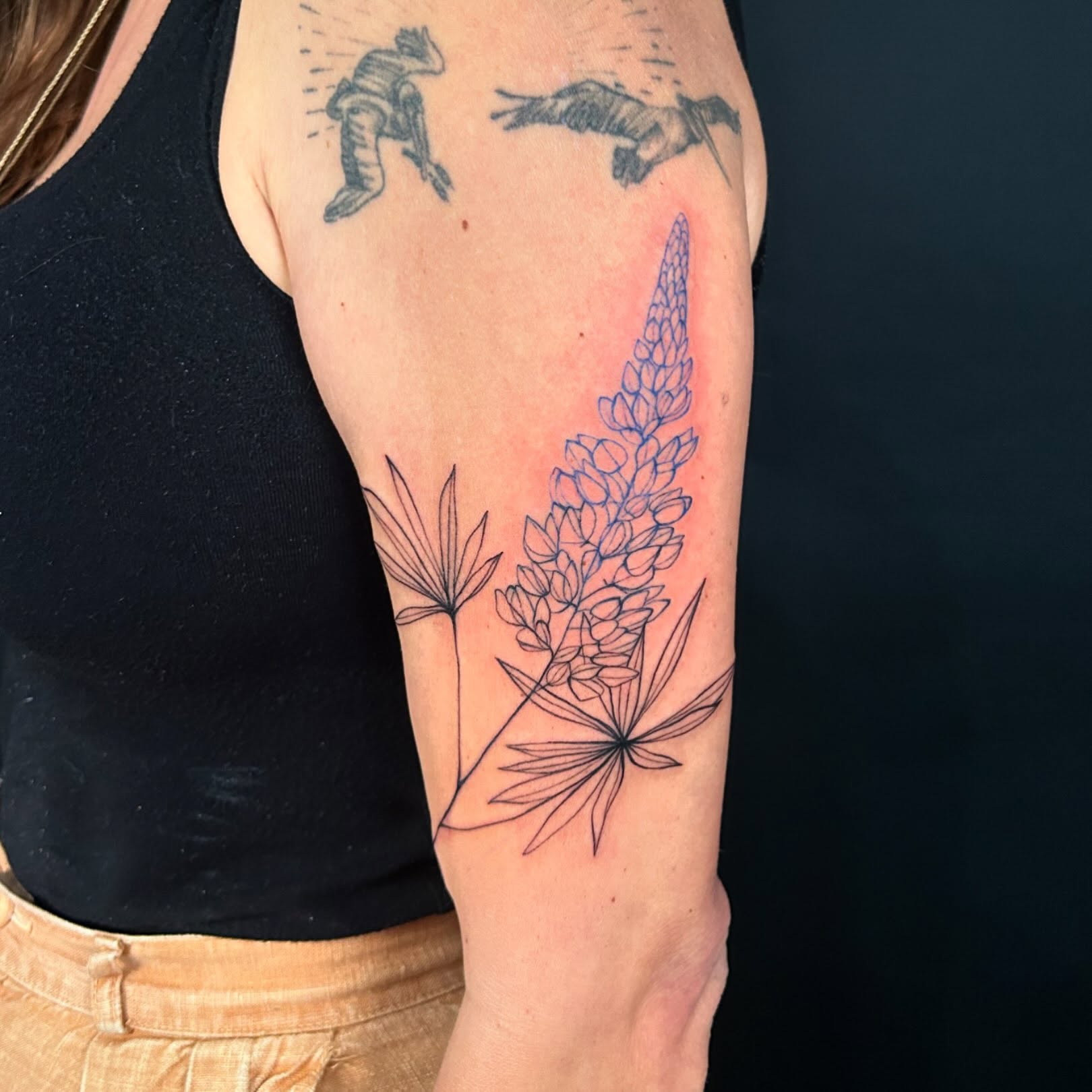 Lupine flower fine line tattoo on the forearm by @laurabochet_tattoo, Beacon, NY
