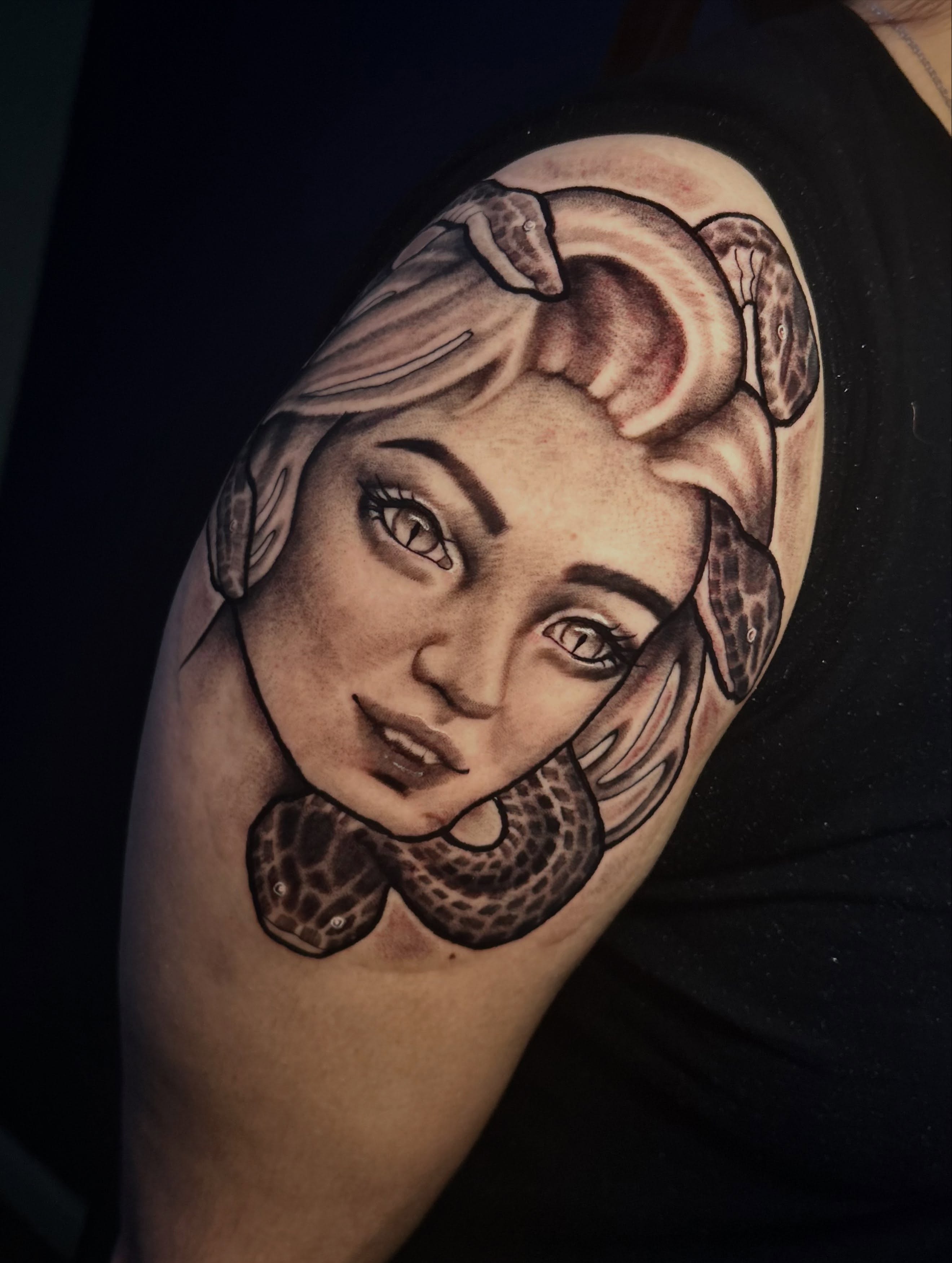 Woman's face with snakes realism tattoo on the shoulder by Adrian Michigan Tattoo Artist