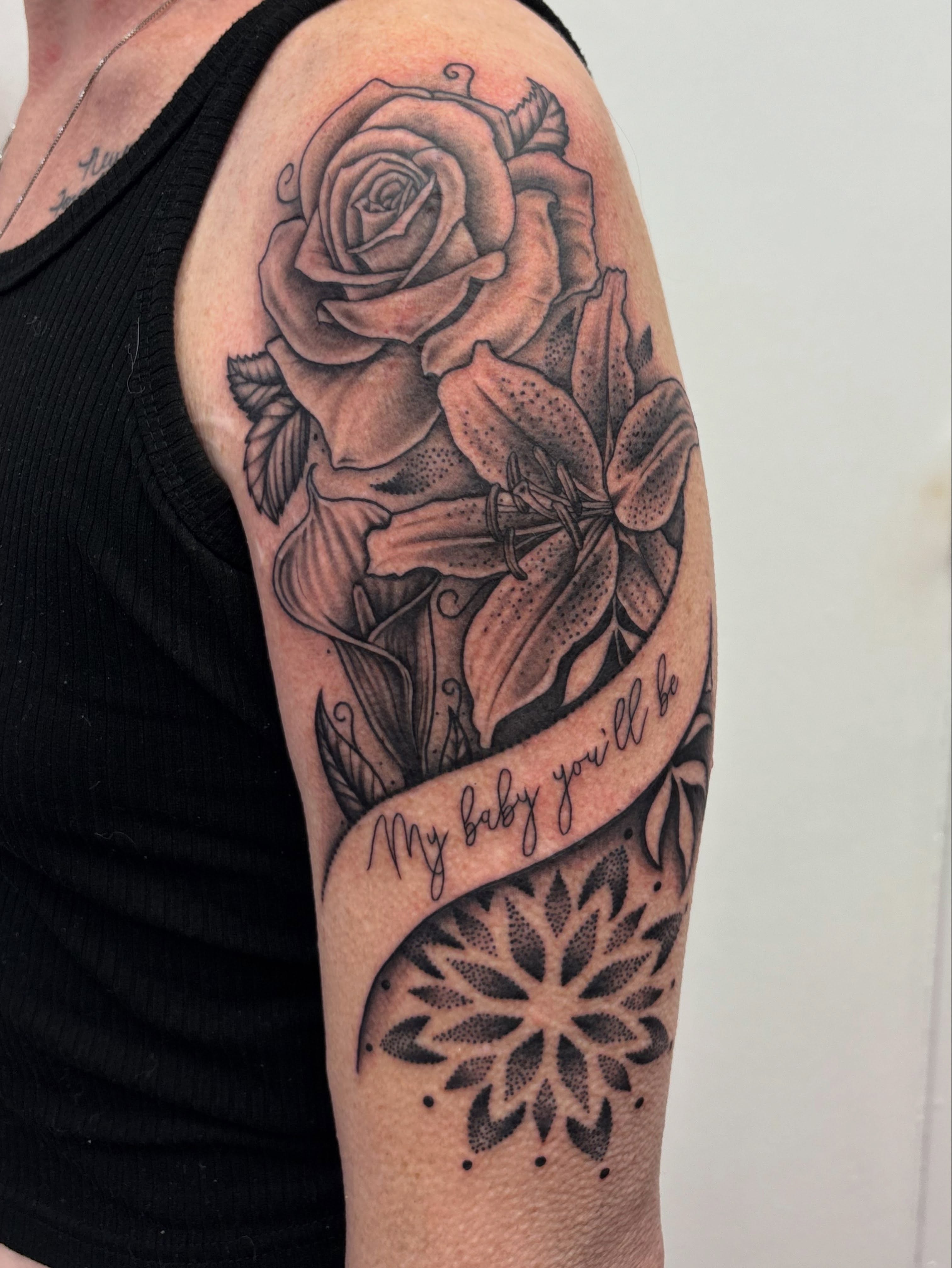 Rose and lily dotwork tattoo on the forearm by Skye California