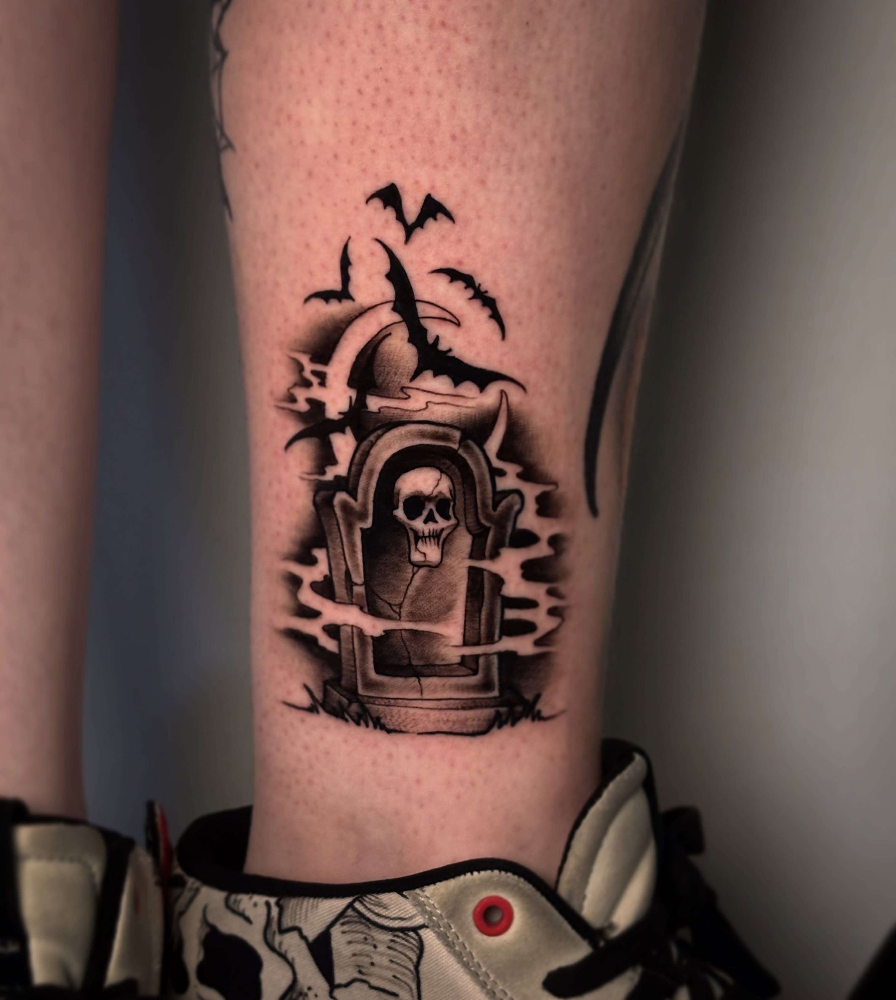 Graveyard with skull black and grey tattoo on the forearm by Riley Borne