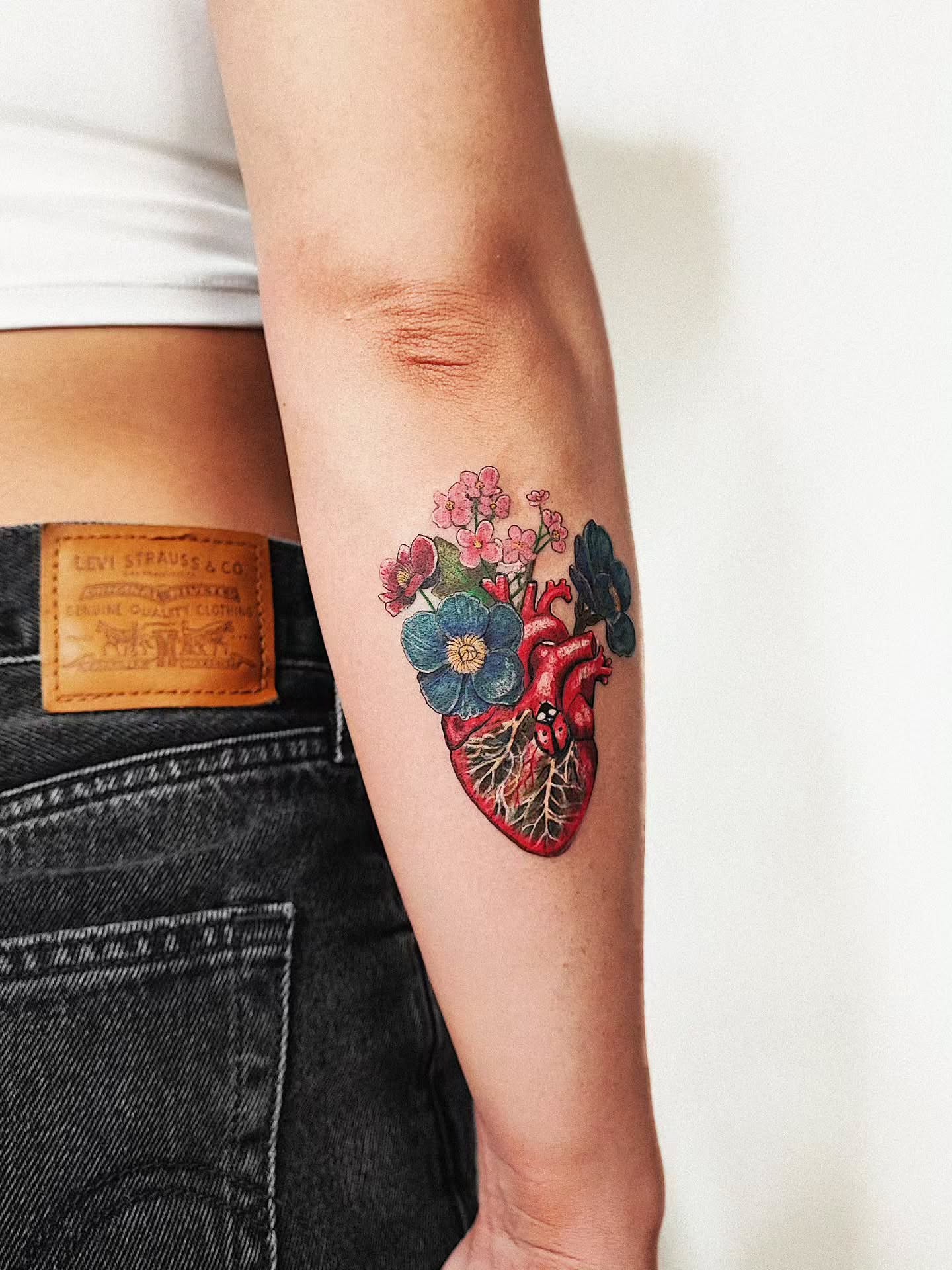 Anatomical heart with flowers realism tattoo on the forearm by 𝗔𝗟𝗘𝗫 𝗣𝗥𝗘𝗤𝗨𝗘𝗟 𝗧𝗔𝗧𝗧𝗢𝗢𝗦 𝗖𝗛𝗜𝗖𝗔𝗚𝗢 ™, Chicago, Illinois