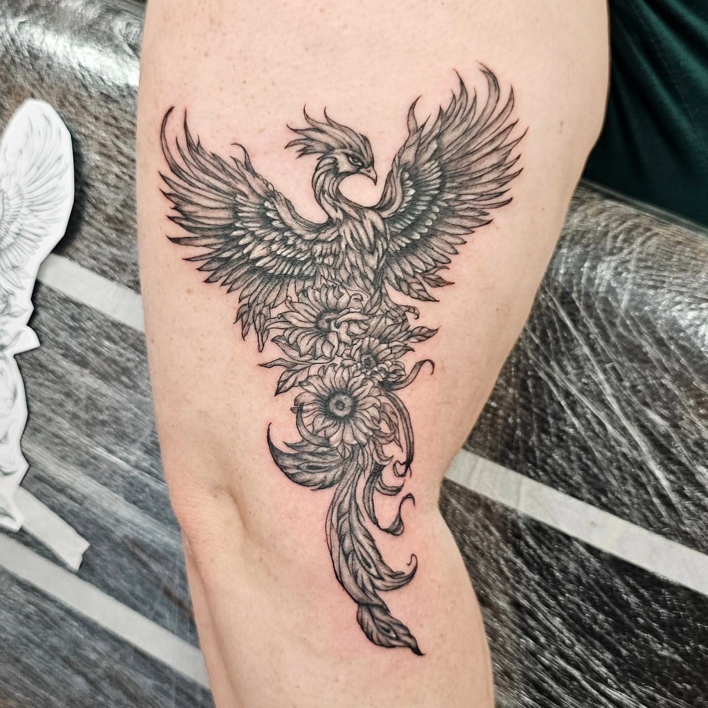 Phoenix black and grey tattoo on the thigh by Lili Gu
