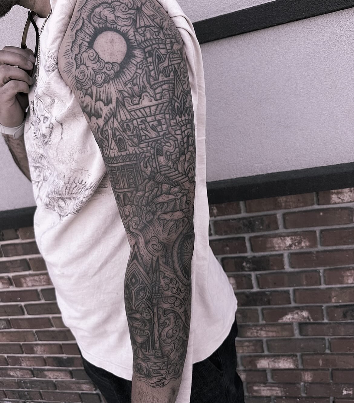 Cityscape black and grey tattoo on the upper arm by Anna Nicole Thomas