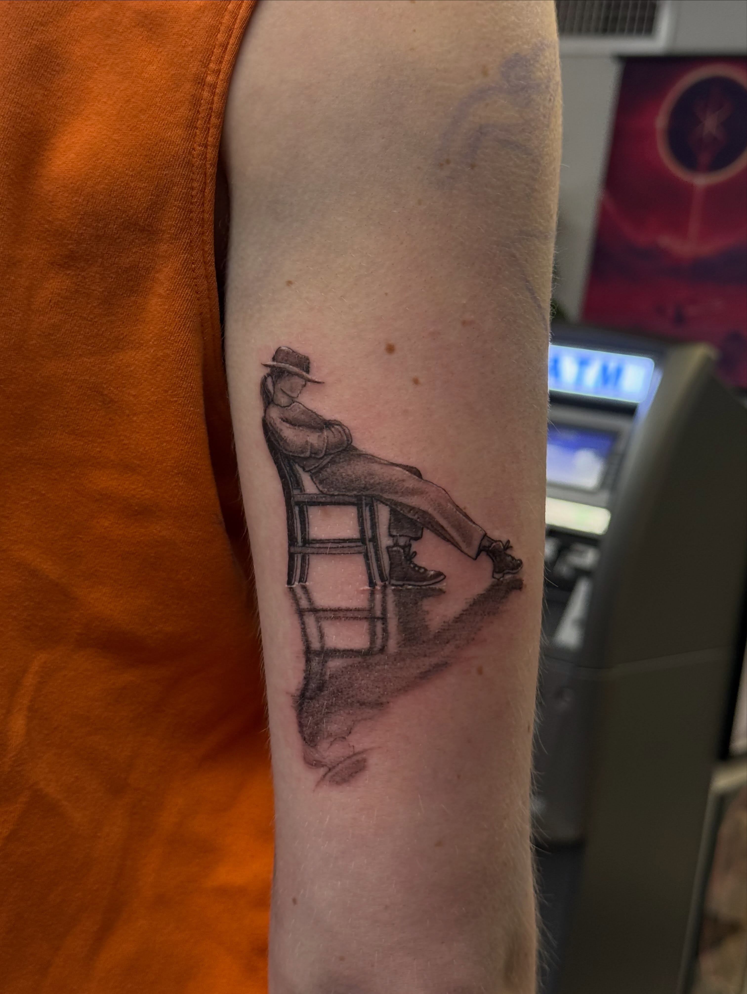Man sitting in chair black and grey tattoo on the forearm by Khang🇻🇳