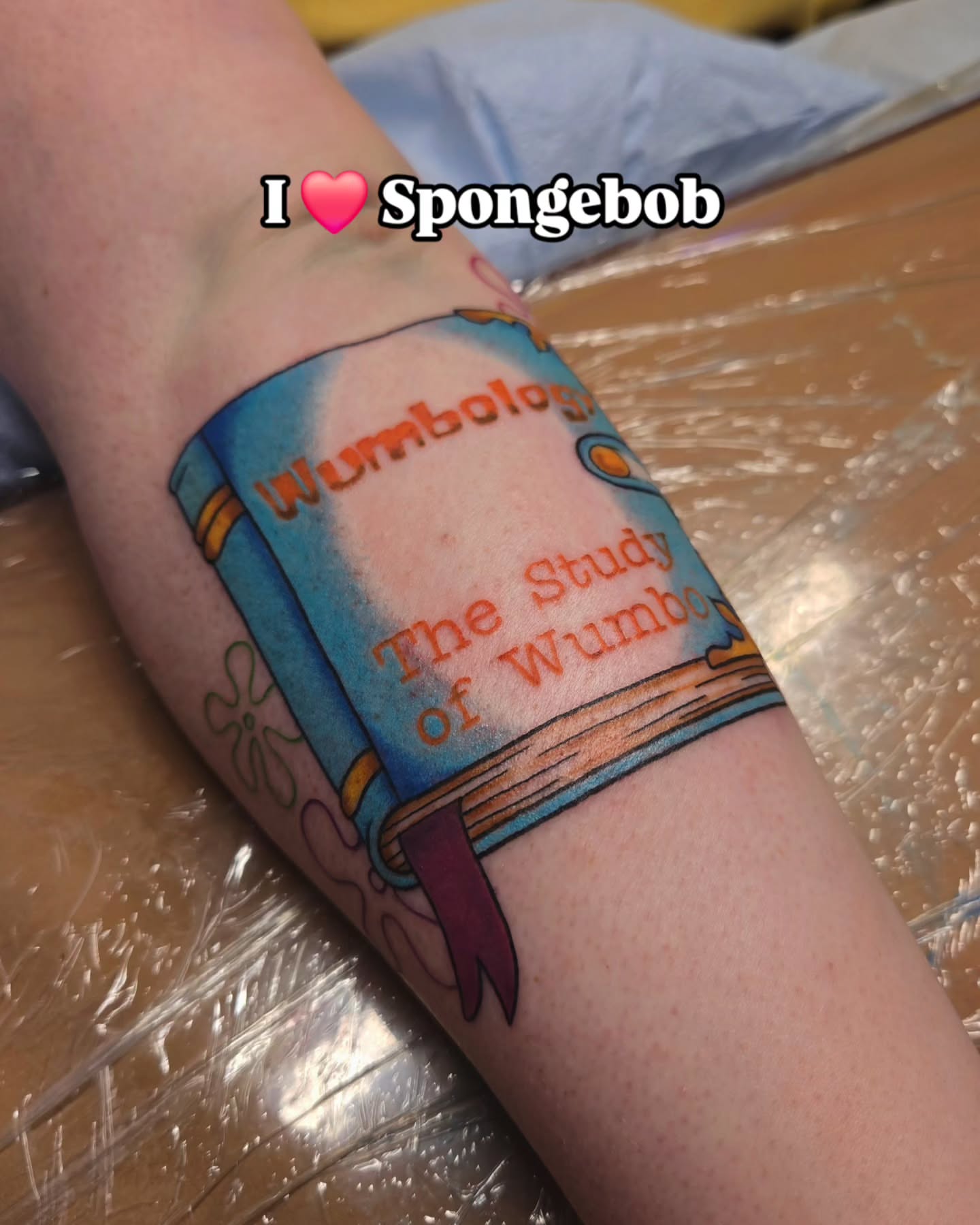 Book cover illustrative tattoo on the forearm by jo(rdan)