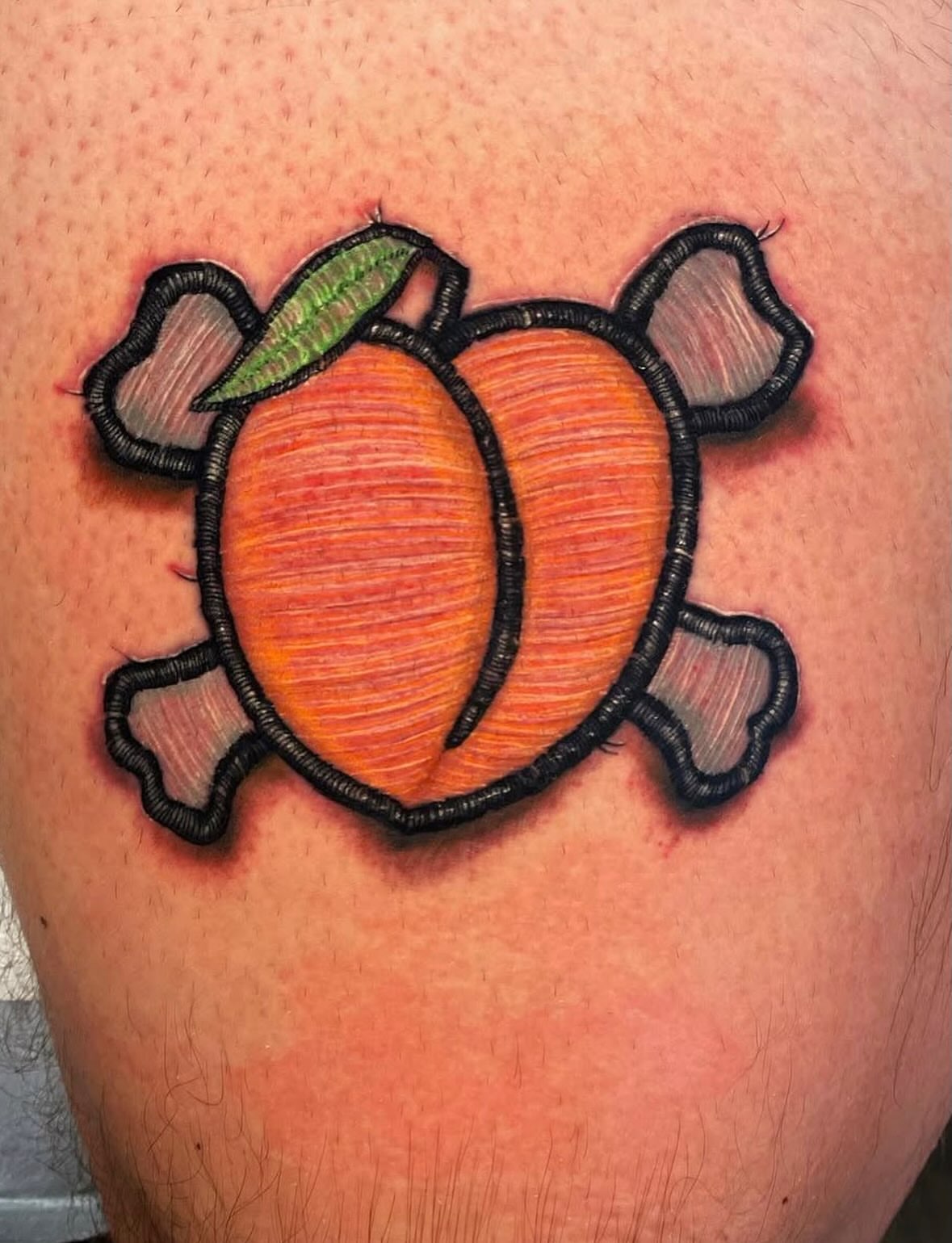 Peach American traditional tattoo on the thigh by Tattoos by Fesik LLC