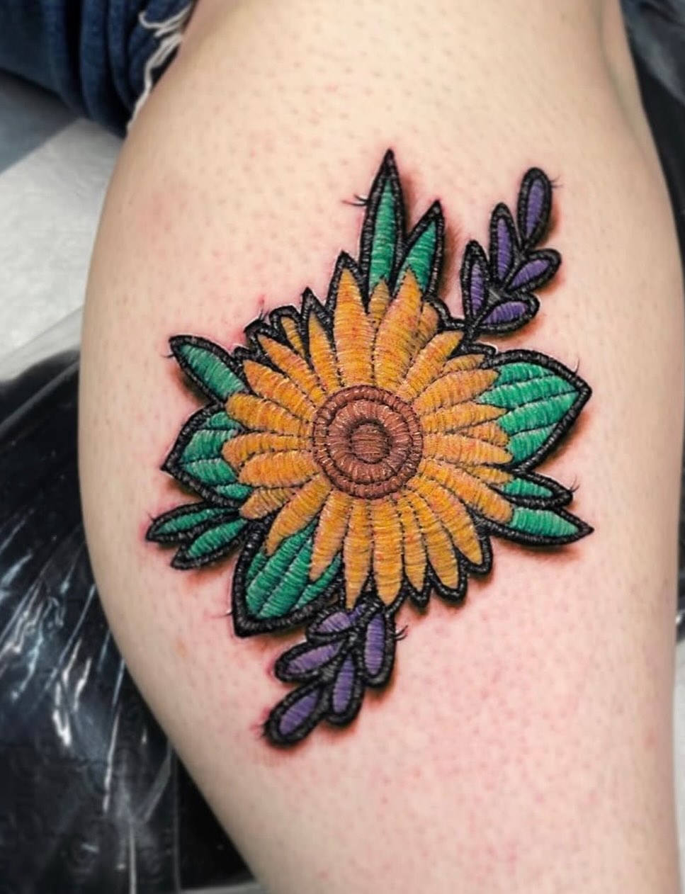 Sunflower realism tattoo on the thigh by Tattoos by Fesik LLC
