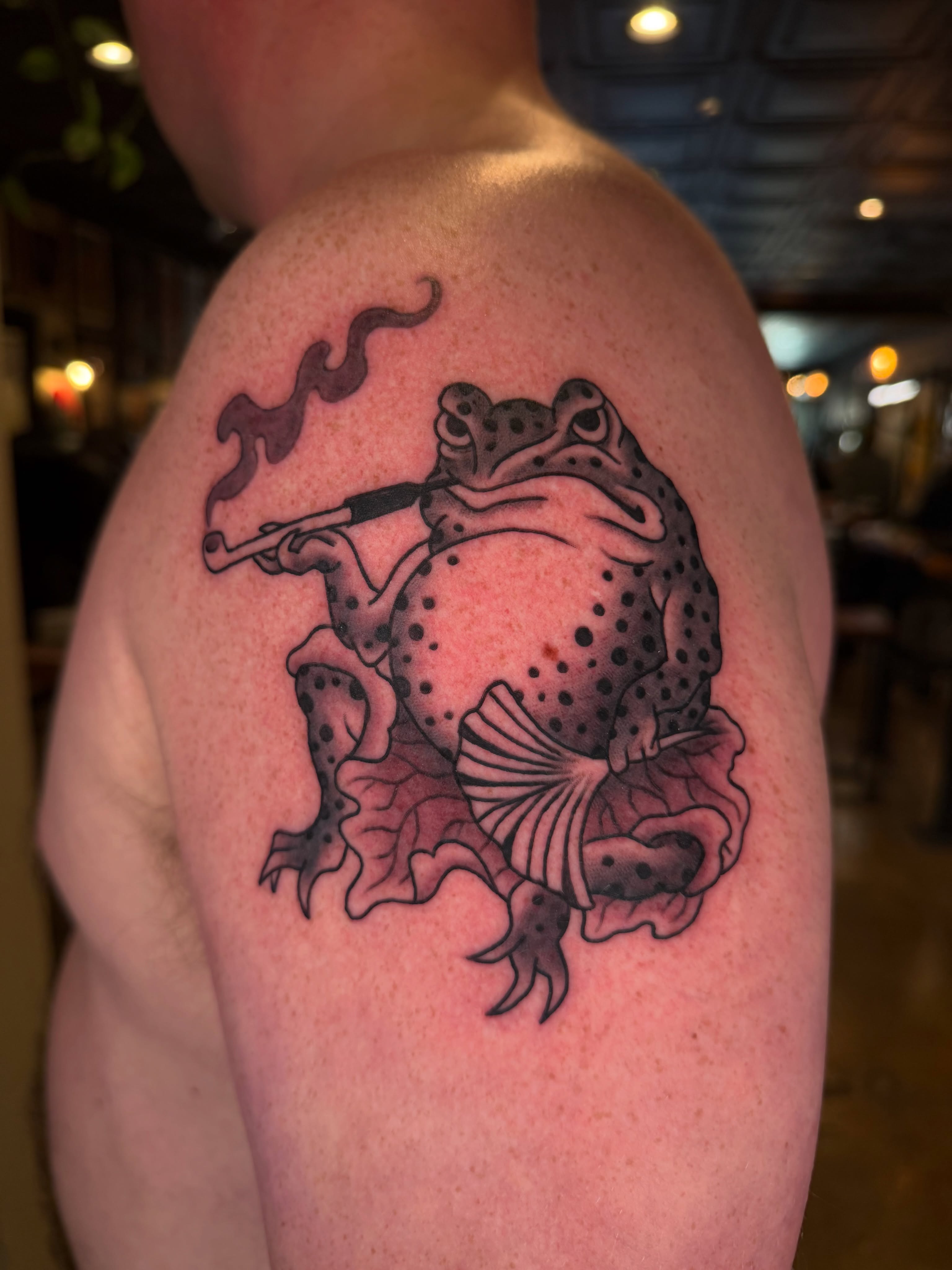 Frog smoking pipe dotwork tattoo on the shoulder by Tyler Brown, San Diego, California