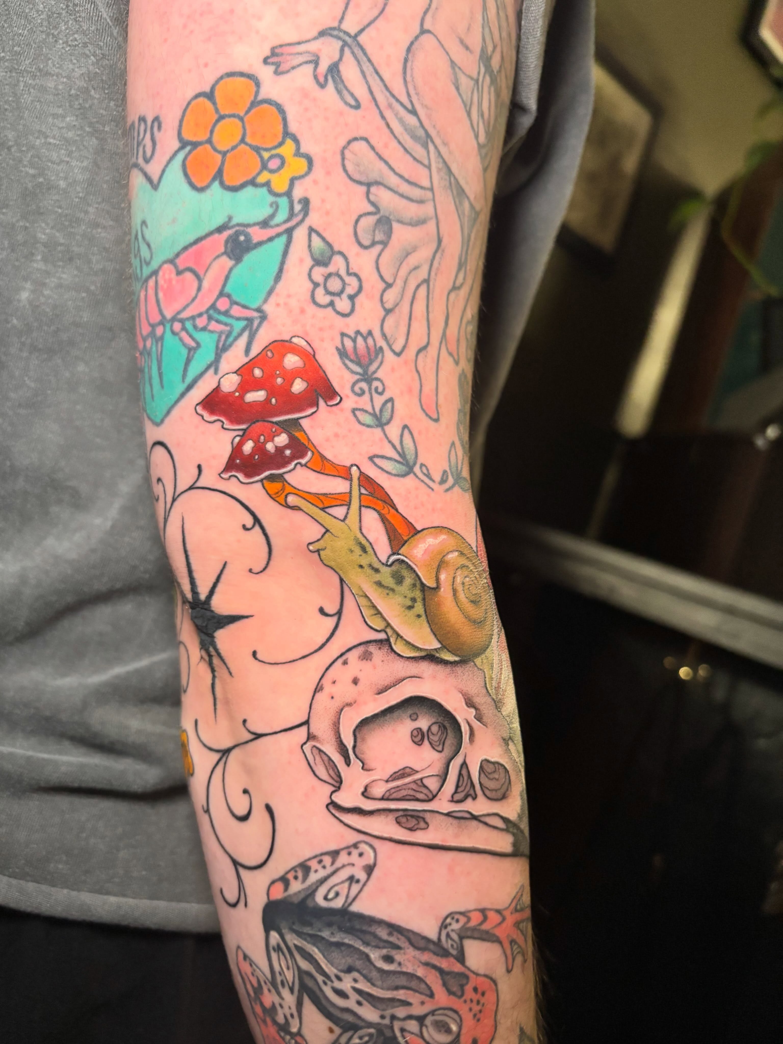 Snail and mushrooms American traditional tattoo on the forearm by Wren Hollow, Portland, Oregon
