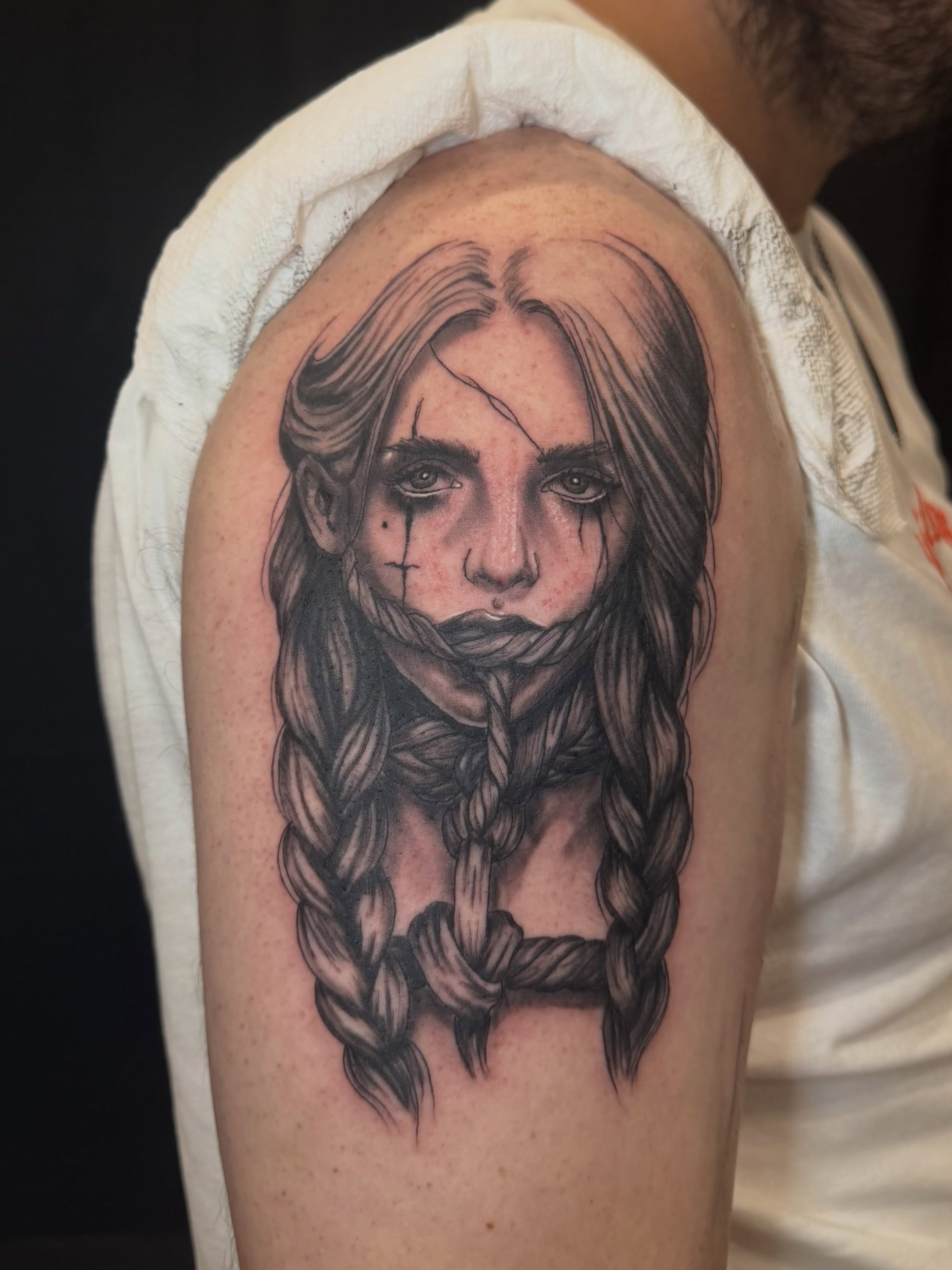 Girl with braids realism tattoo on the shoulder by Zeninkz