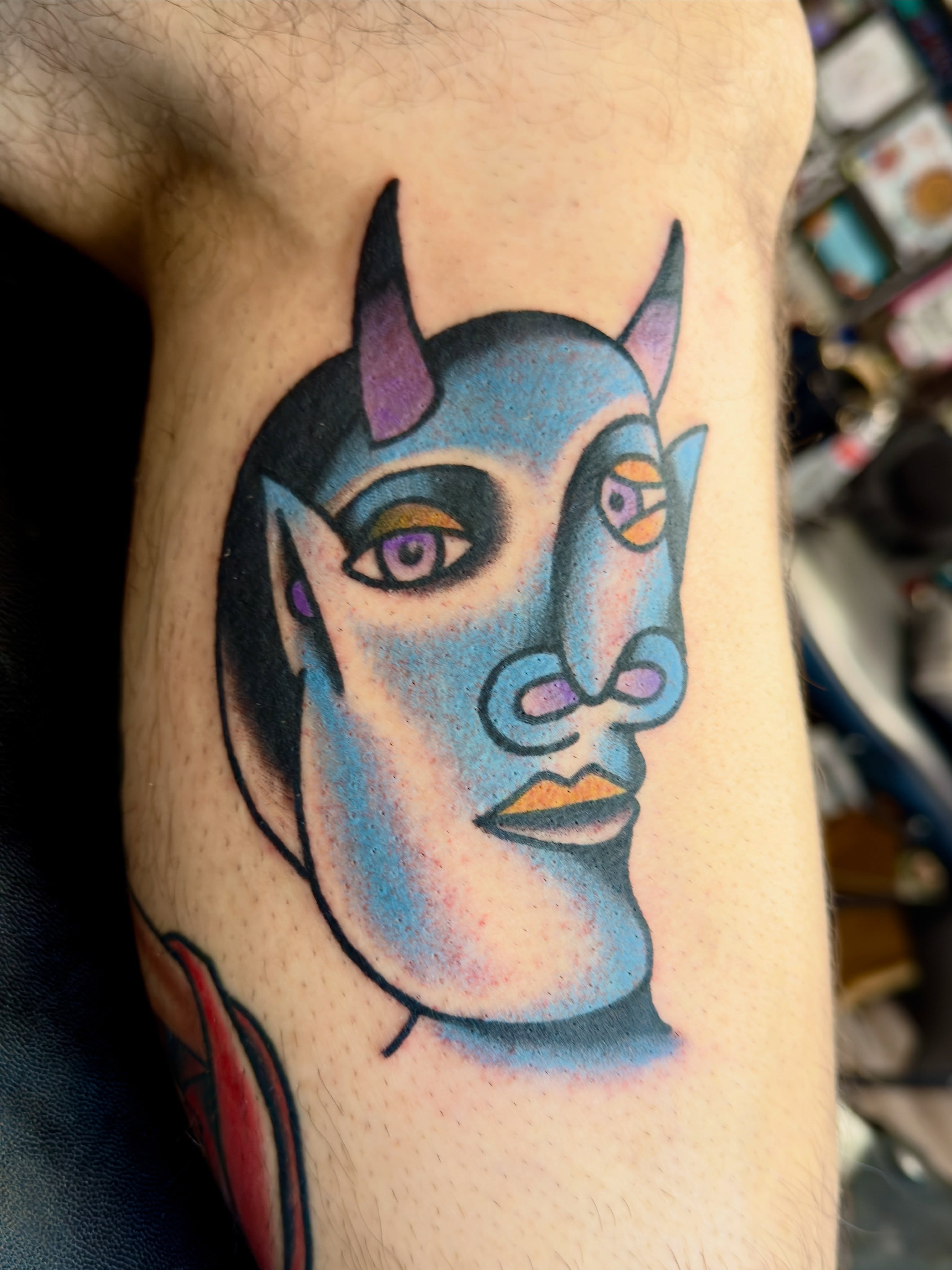 Demonic face geometric tattoo on the forearm by Jimmy Kelley