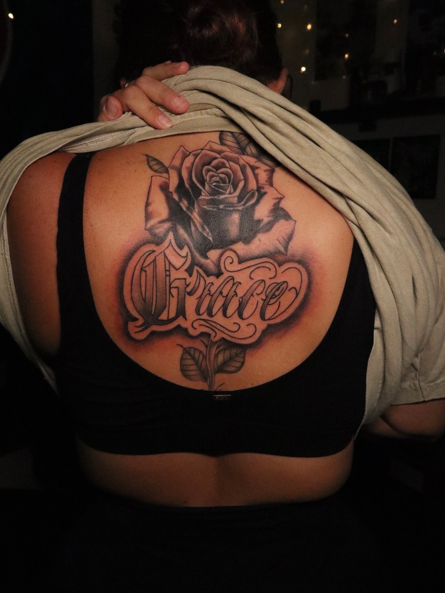 Rose and script realism tattoo on the back by Dee