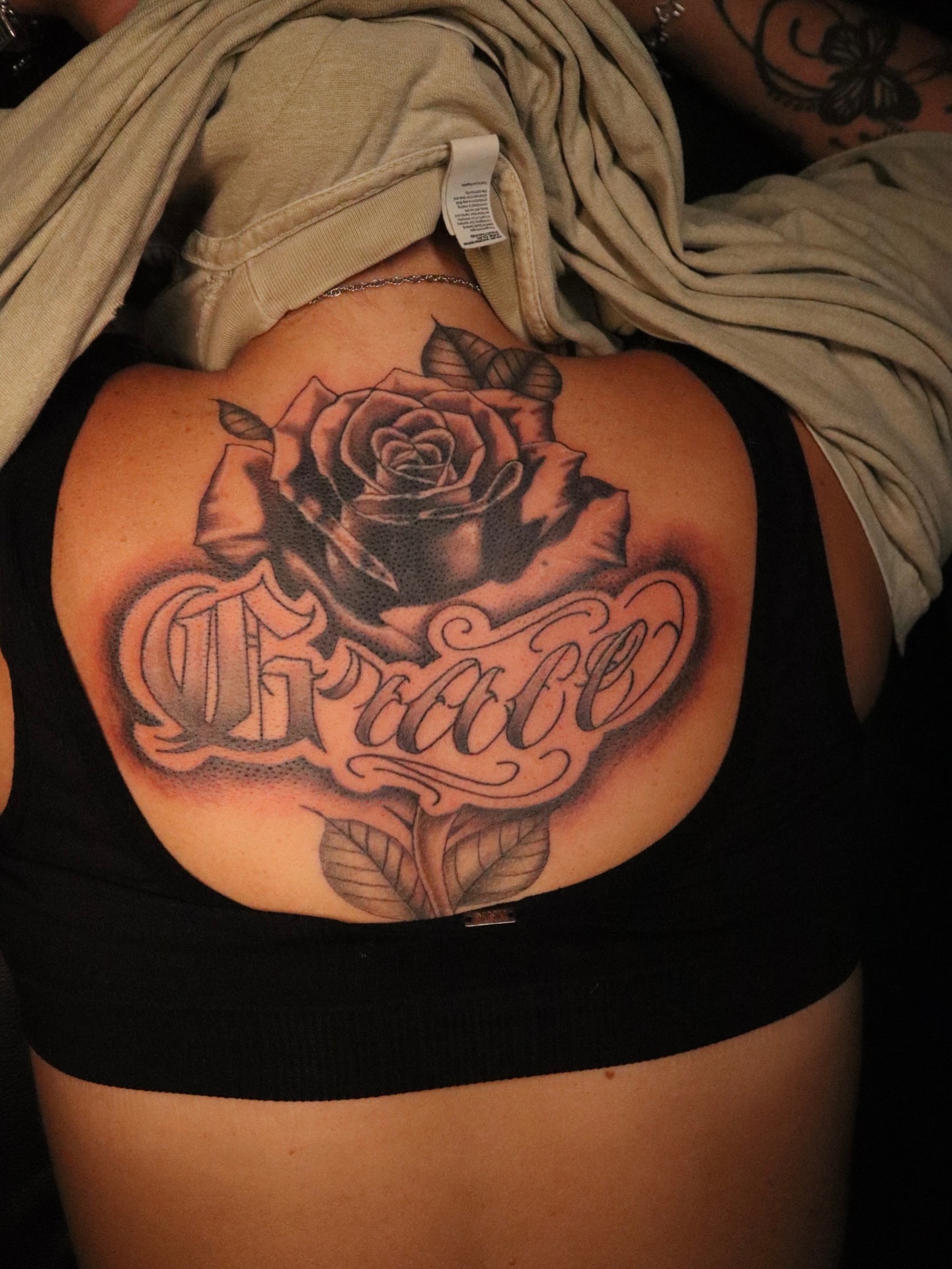 Rose and script dotwork tattoo on the back by Dee