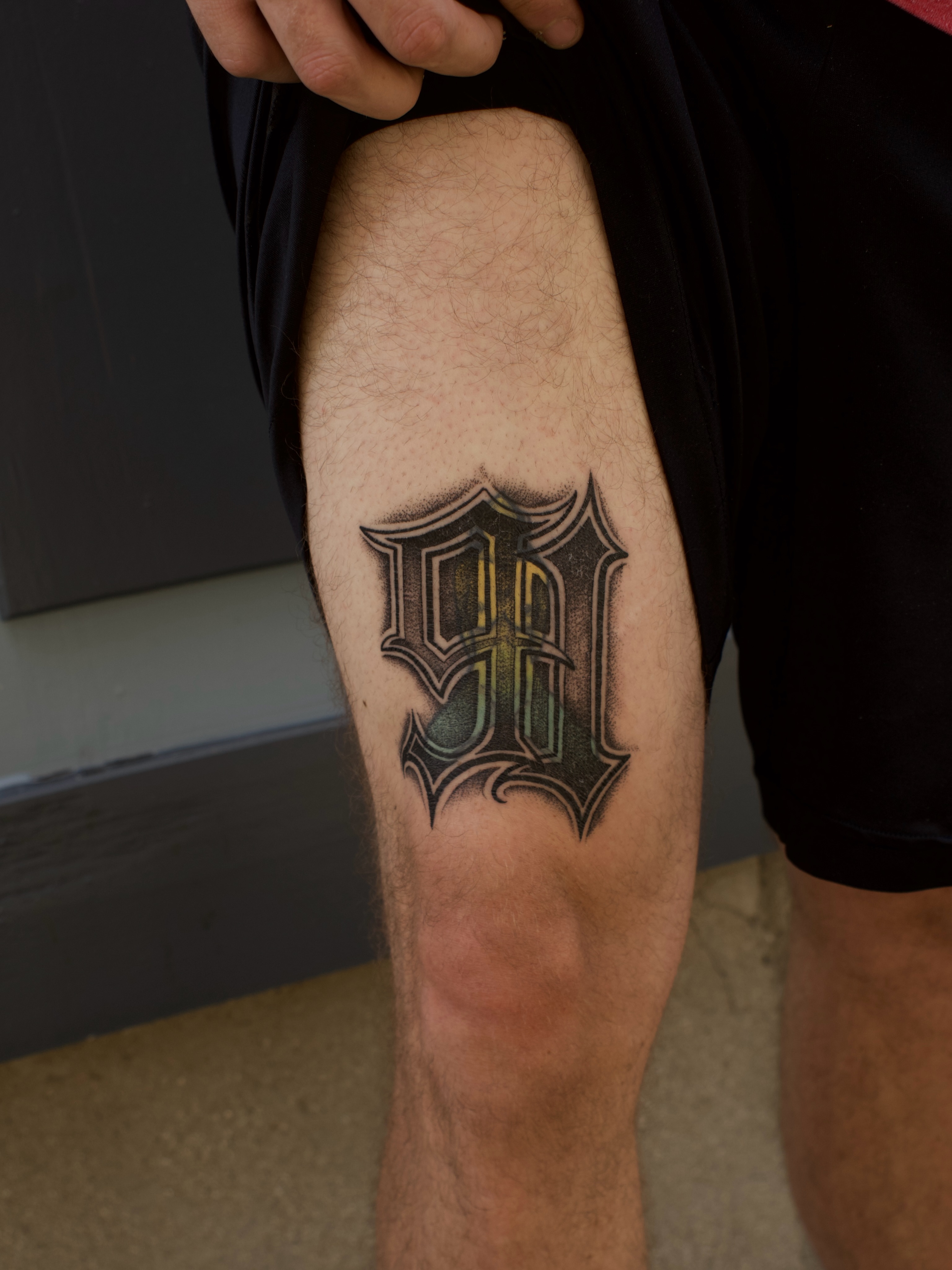 Lettering black and grey tattoo on the calf by Kevin Rotramel, Dayton, Ohio